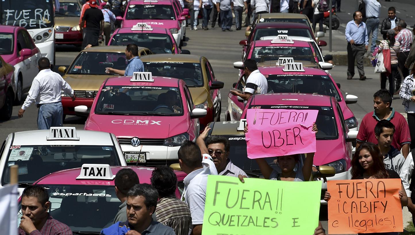Taxi drivers taking part in a protest against private cab company Uber for alleged unfair competition in Mexico City on May 25, 2015. -- PHOTO: AFP