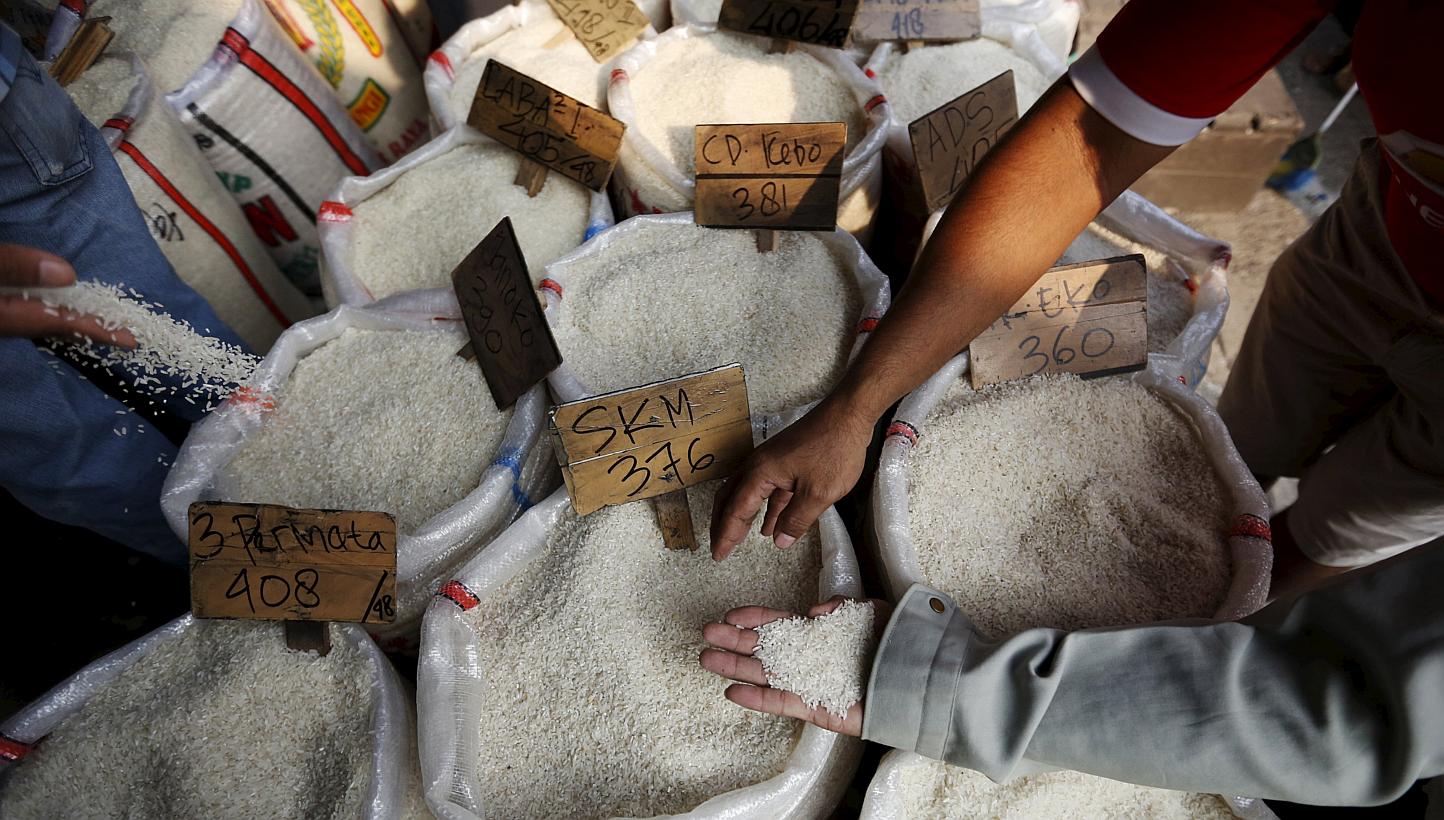 Customers checking the quality of rice at a wholesale rice market in east Jakarta last week. One lab test on rice samples collected from a stall in Bekasi showed traces of PVC. -- PHOTO: REUTERS