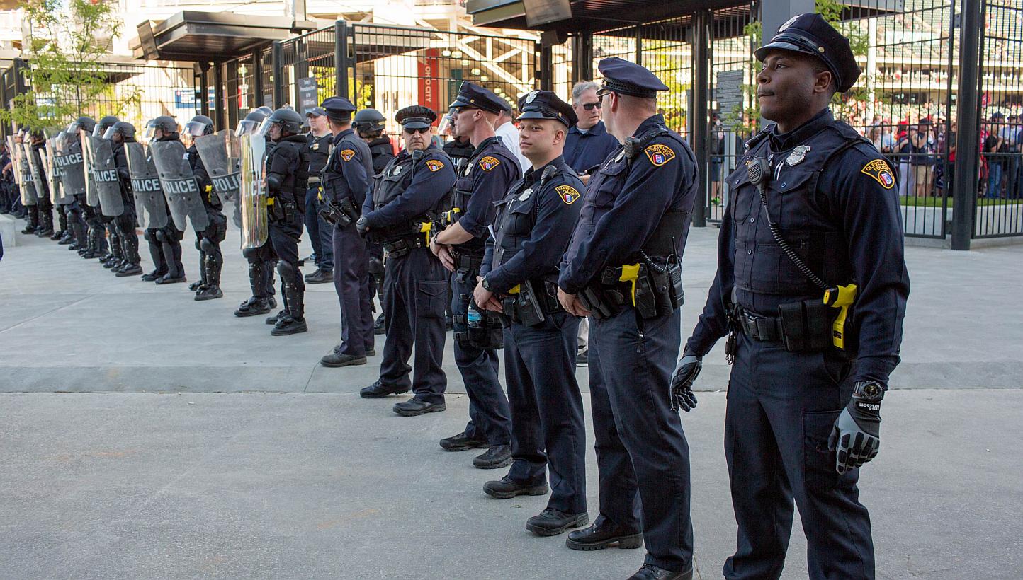 Police in front of Progressive Field stand guard during demonstrations in reaction to Cleveland police officer Michael Brelo being acquitted of manslaughter charges after he shot two people at the end of a 2012 car chase in which officers fired 137 s