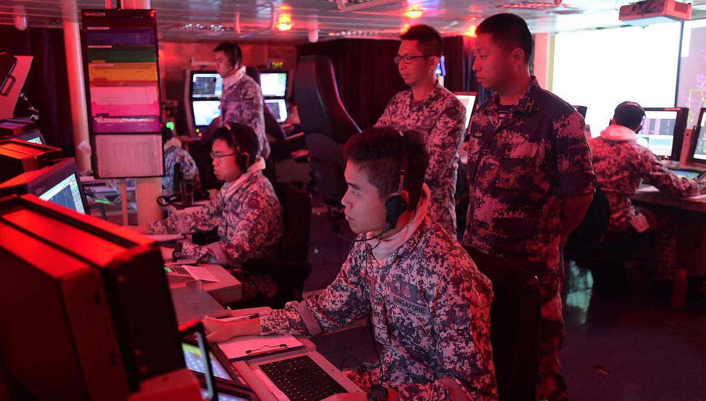 A PLA(N) officer (right, standing) observing the conduct of the Air Defence component of Exercise Maritime Cooperation in the Combat Information Centre of RSS Intrepid. The Republic of Singapore Navy (RSN) and the People's Liberation Army (Navy) (PLA