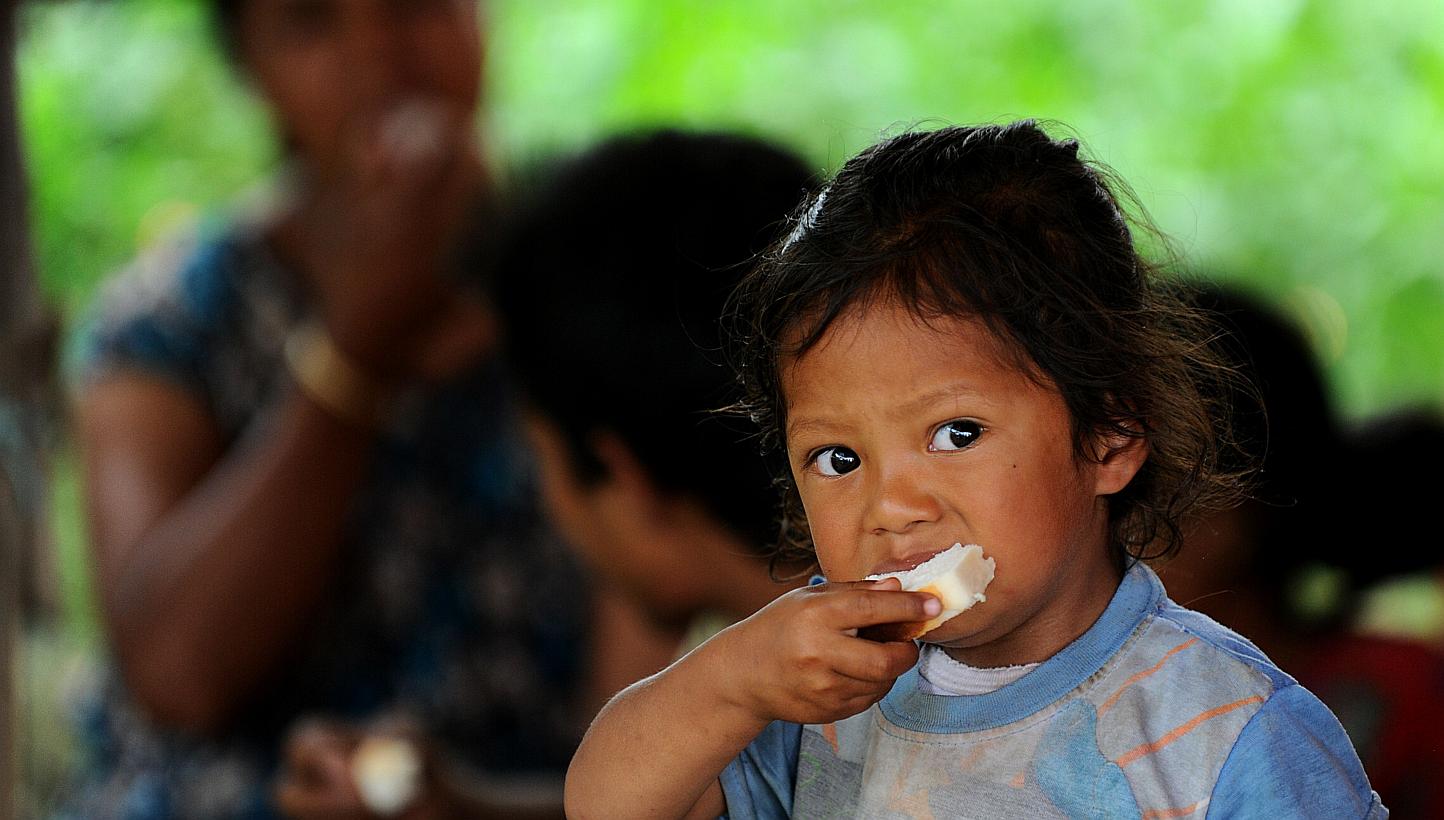 A Nepalese child eats at a relief camp for survivors of the Nepal earthquake in Baktarpur on the outskirts of Kathmandu on May 20, 2015. Nepal on Tuesday, May 26, banned children from travelling without parents or approved guardians in a bid to deter