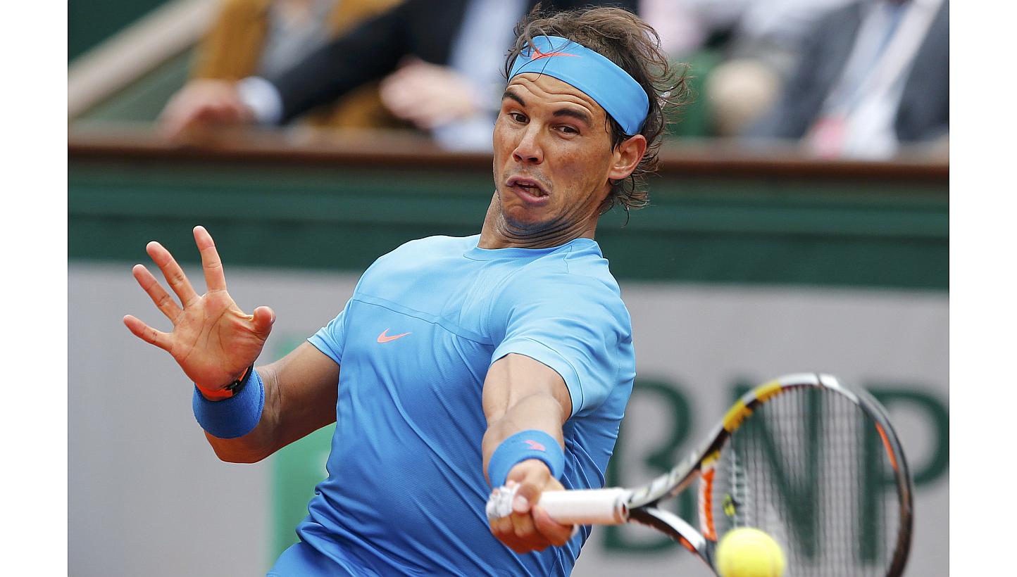 Rafael Nadal of Spain plays a shot to Quentin Halys of France during their men's singles match at the French Open tennis tournament at the Roland Garros stadium in Paris, France on May 26, 2015. -- PHOTO: REUTERS &nbsp;
