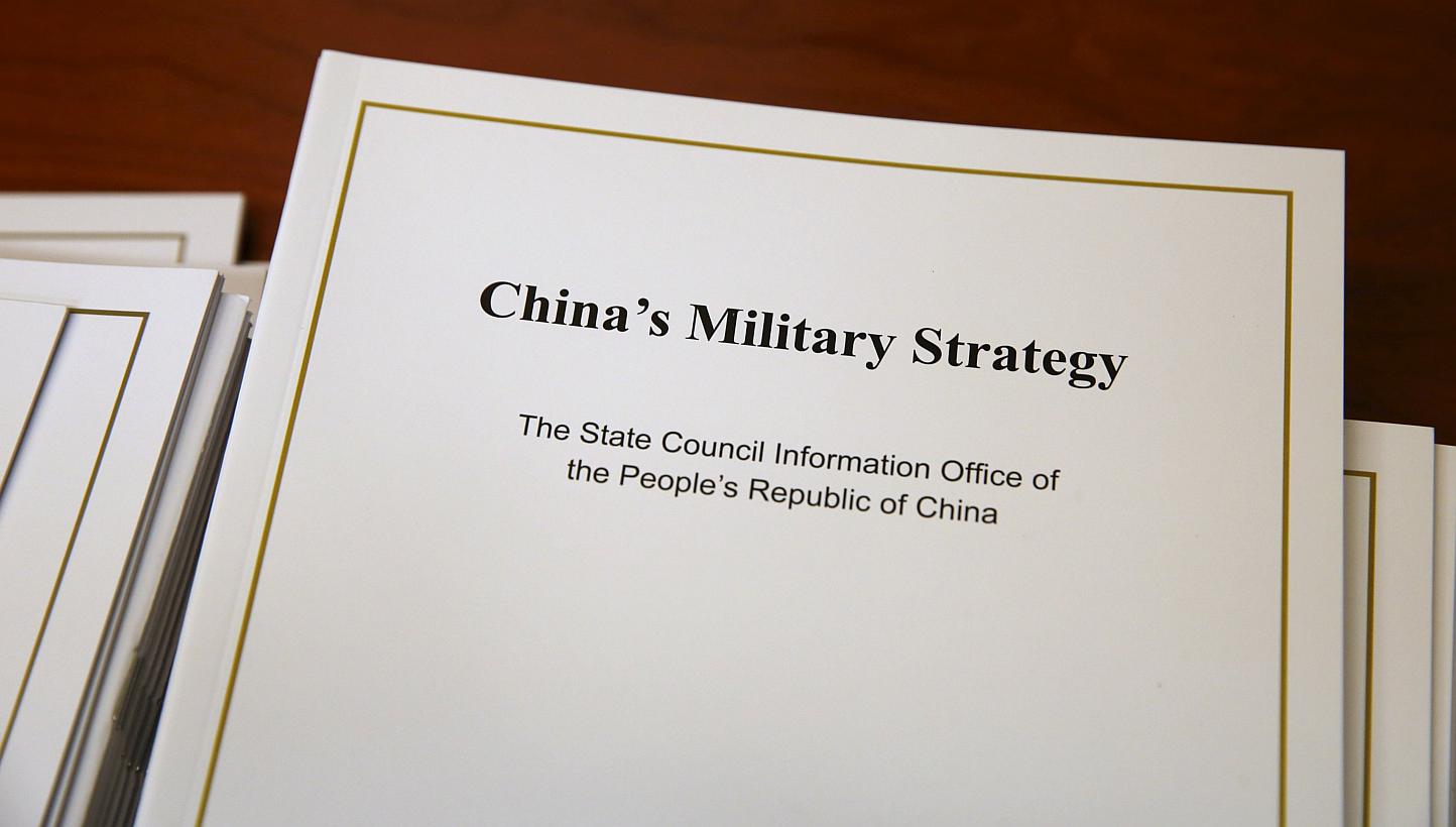 Copies of the annual white paper on China's military strategy are placed on a table for distribution to journalists during a news conference in Beijing, China, May 26, 2015. China outlined a defence strategy on Tuesday to boost its naval capability f