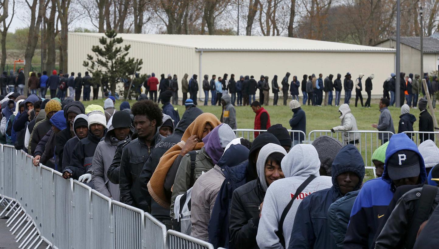 Migrants from Africa, Afghanistan and Syria queue for an evening meal at the Jules Ferry day centre in Calais, France on April 29, 2015. -- PHOTO: REUTERS