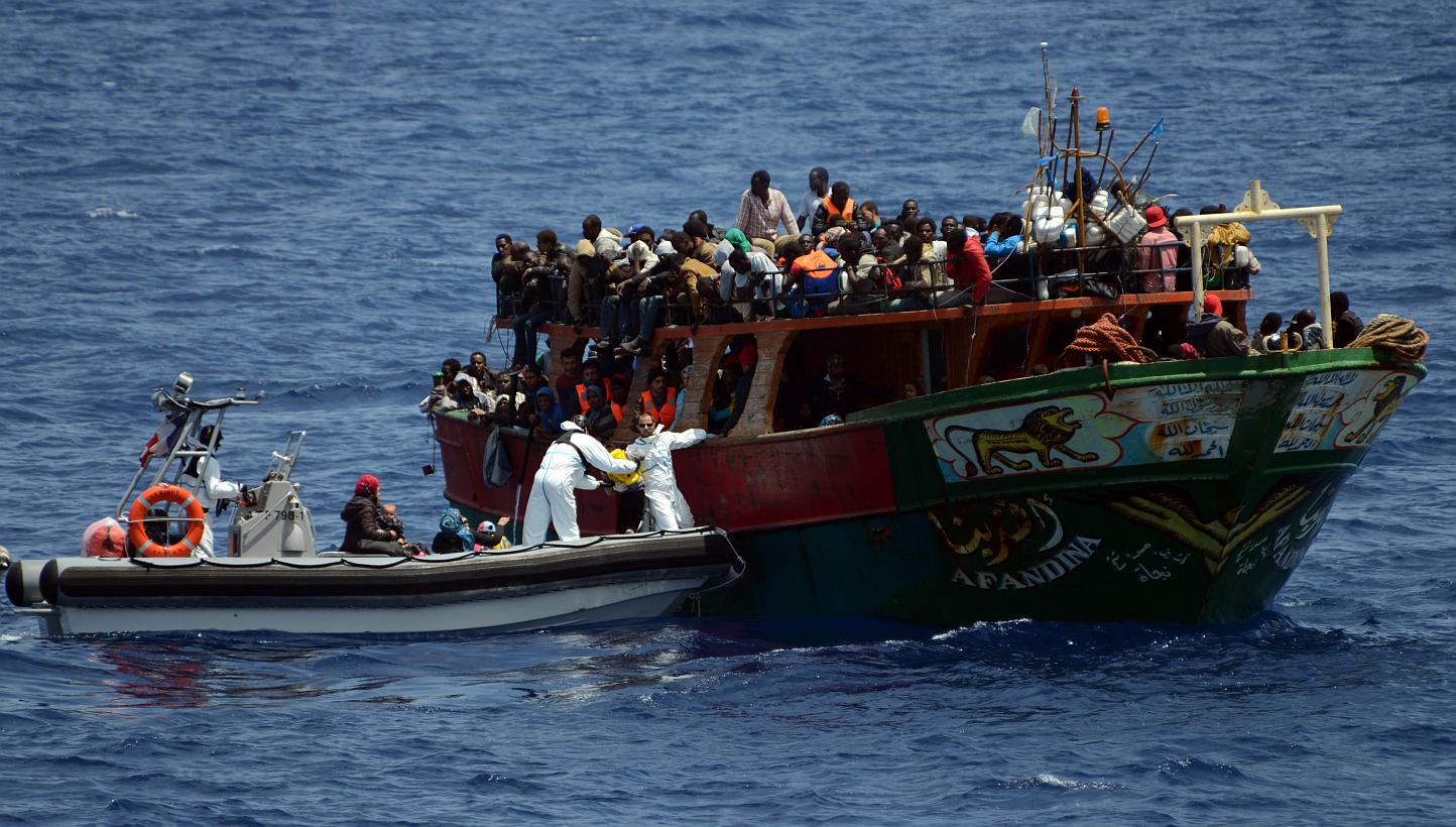 Crew members of the French Navy patrol ship Commandant Birot taking part in an operation to rescue 297 migrants who were on board the fishing boat Afandina, in the Mediterranean Sea, on May 20, 2015. -- PHOTO: AFP&nbsp;
