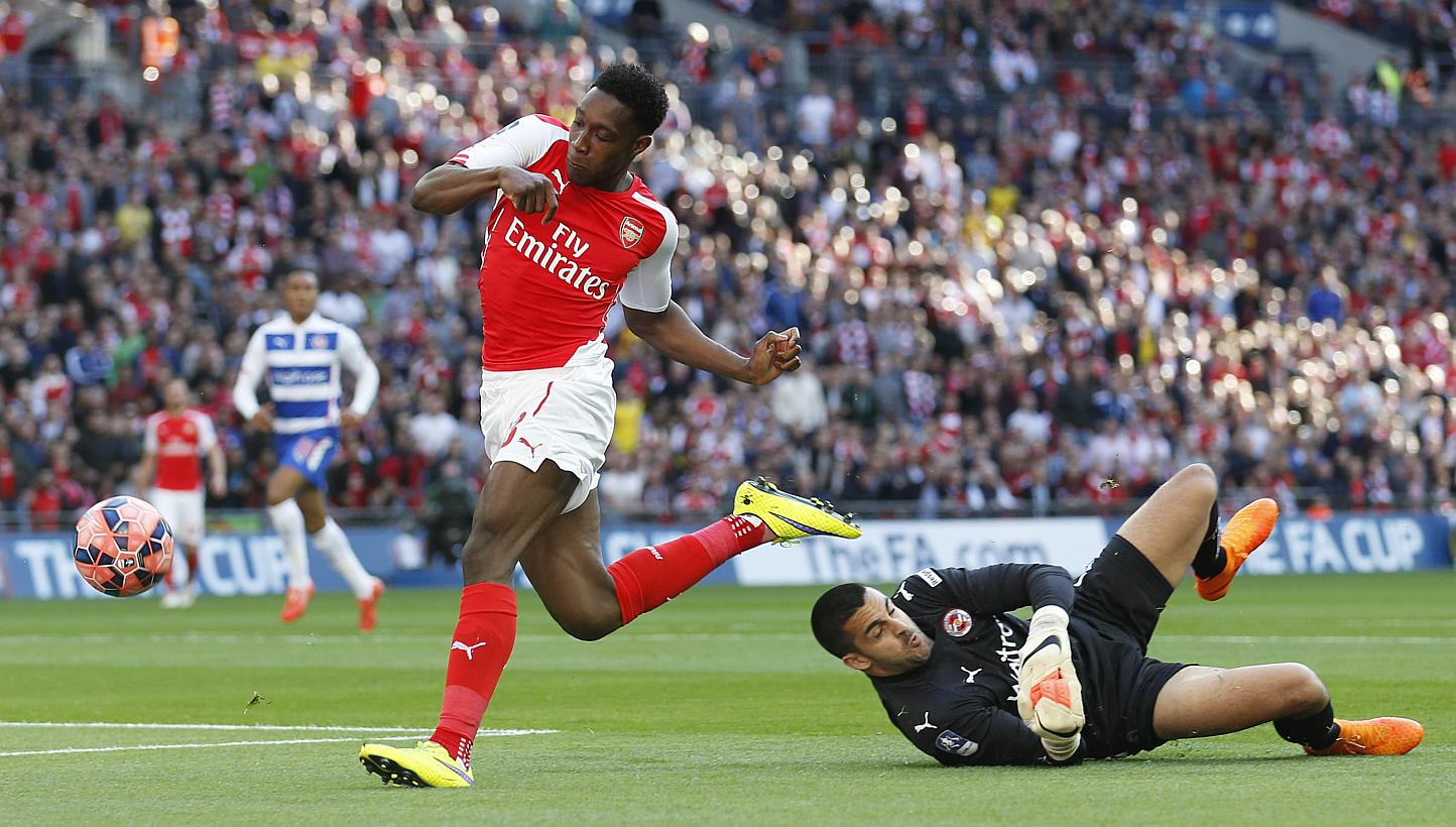 Arsenal's Danny Welbeck (left) pushes the ball past Reading keeper Adam Federici during the FA Cup Semi Final at Wembley Stadium on April 18, 2015. Arsenal manager Arsene Wenger has said that Welbeck will miss the team's FA Cup Final clash against As