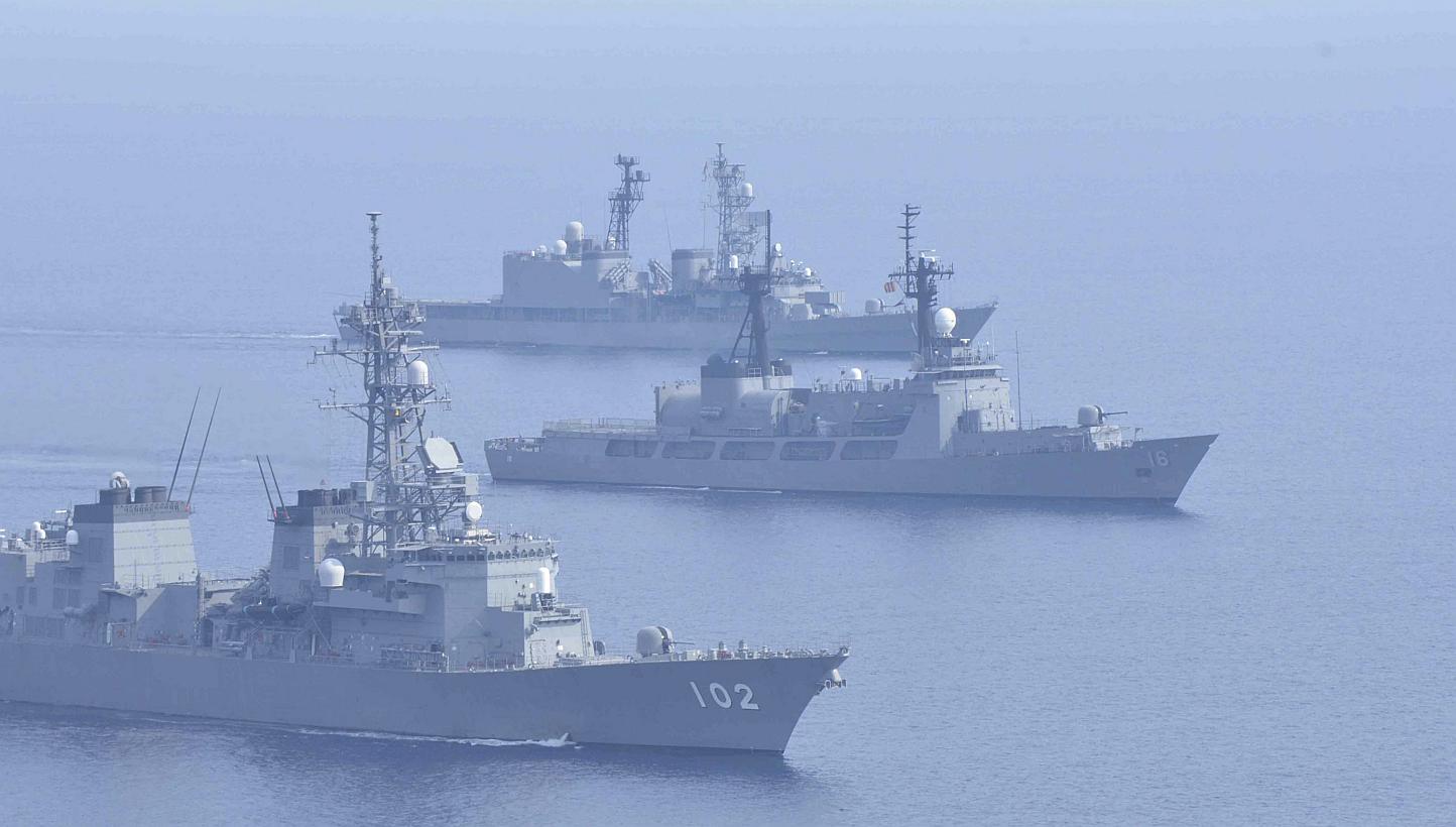 Japanese Maritime Self-Defence Force destroyers Harusame (bottom) and Amagiri (top) sail side by side with Philippine warship BRP Ramon Alcaraz during a joint naval drill in the South China Sea on May 12, 2015. The two nations are set to bolster secu