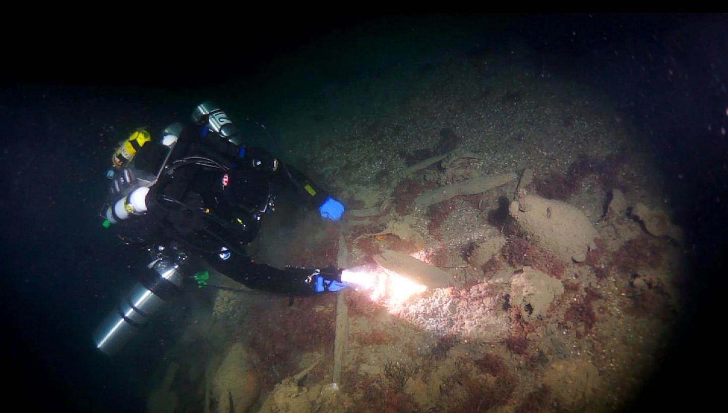 An undated handout picture released by Russia's Rostov Dive divers club shows a diver observing ancient amphoras at the site of a Byzantine shipwreck off the city of Sevastopol. -- PHOTO: AFP/ RUSSIA'S ROSTOV DIVE DIVERS CLUB