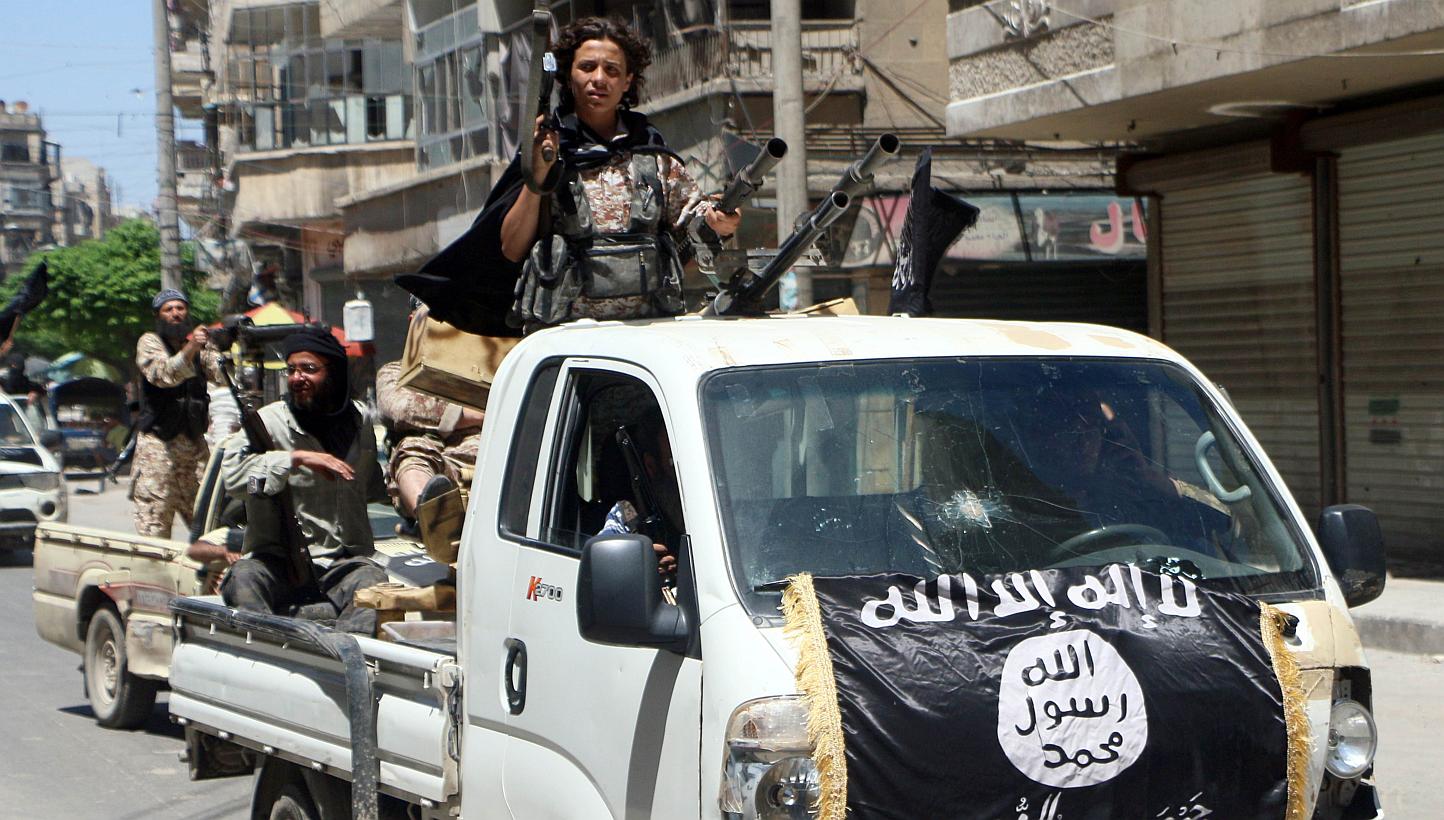 Fighters from Al-Qaeda's Syrian affiliate Al-Nusra Front driving in armed vehicles in the northern Syrian city of Aleppo as they head to a frontline, on May 26, 2015. -- PHOTO: AFP