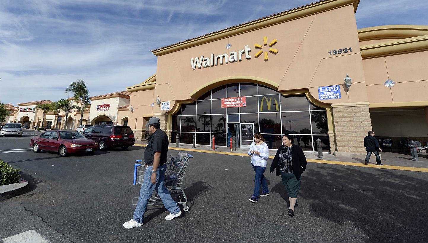 Customers walking outside a Walmart store in the Porter Ranch section of Los Angeles on Nov 26, 2013. -- PHOTO: REUTERS
