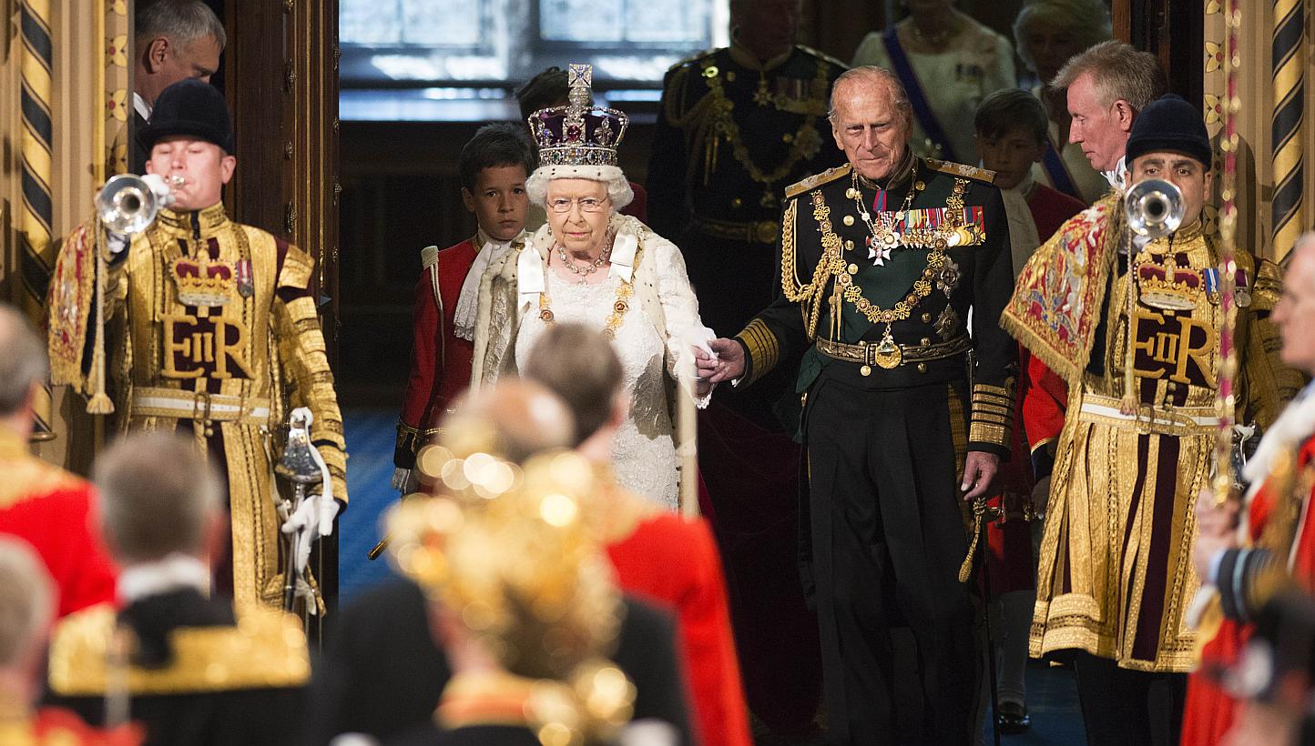 Britain's Queen Elizabeth II (second, left) accompanied by Prince Philip, Duke of Edinburgh (third, right) entering the Royal Gallery during the State Opening of Parliament at the Palace of Westminster in central London on May 27, 2015. -- PHOTO: AFP