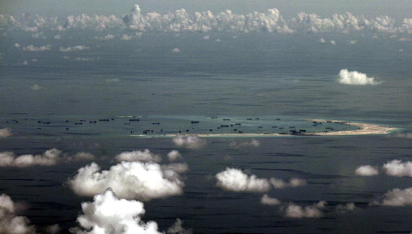 An aerial file photo taken though a glass window of a Philippine military plane shows the alleged on-going land reclamation by China on Mischief Reef in the Spratly Islands in the South China Sea, west of Palawan, Philippines, on May 11, 2015. -- PHO