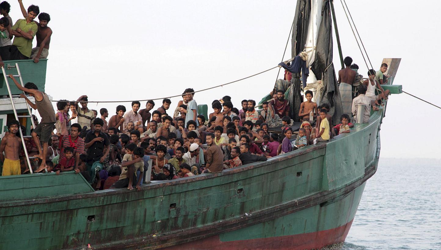 Rohingya and Bangleshi migrants waiting on board a fishing boat before being transported to shore, off the coast of Julok, in Aceh province on May 20, 2015, in this photo taken by Antara Foto. -- PHOTO: REUTERS