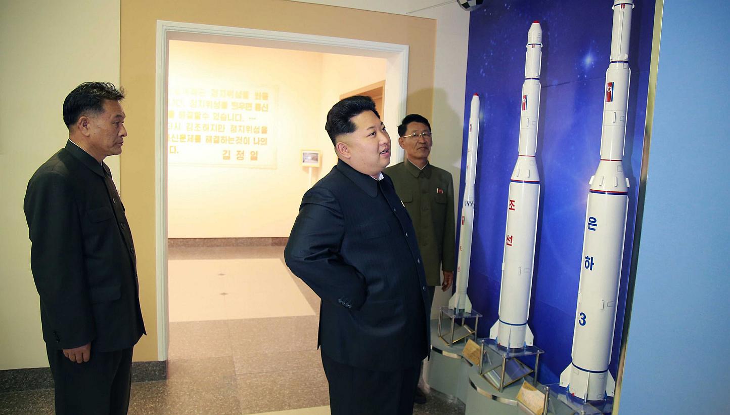 This undated picture released by North Korea's official Korean Central News Agency (KCNA) on May 3, 2015, shows North Korean leader Kim Jong Un (centre) inspecting the newly-built General Satellite Control and Command Centre of the National Aerospace