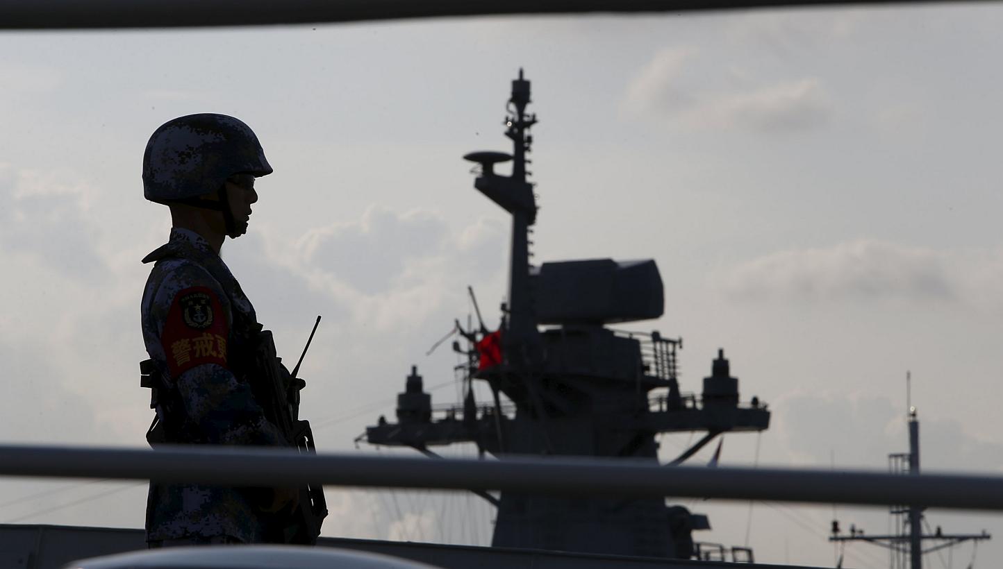 A member of the People's Liberation Army navy standing guard on a Chinese vessel. China's White Paper released on Tuesday paints a new and expansive view of the country's maritime power, while signalling a shake-up of some traditional combat structur
