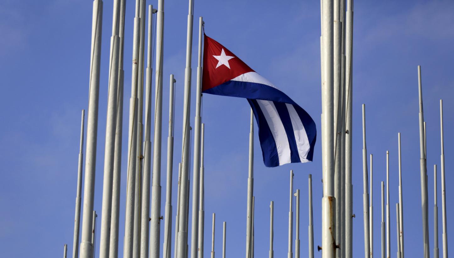 The Cuban flag flies in front of the US Interests Section (background), in Havana May 22, 2015. -- PHOTO: REUTERS&nbsp;