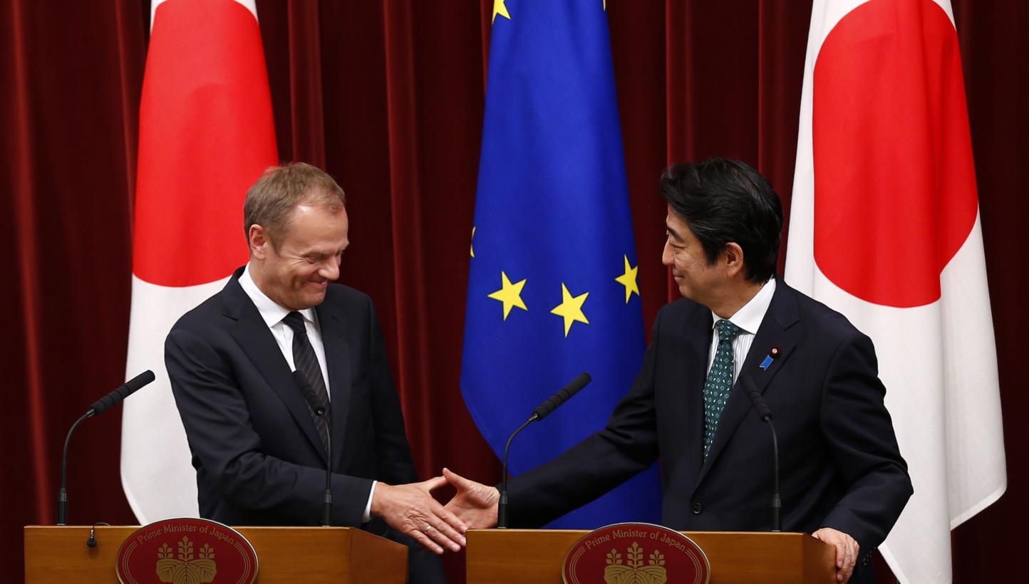 Japan' Prime Minister Shinzo Abe and European Council President Donald Tusk shake hands after a joint news conference after a Japan-EU summit meeting in Tokyo on May 29, 2015. The European Union and Japan are concerned about unilateral actions that c