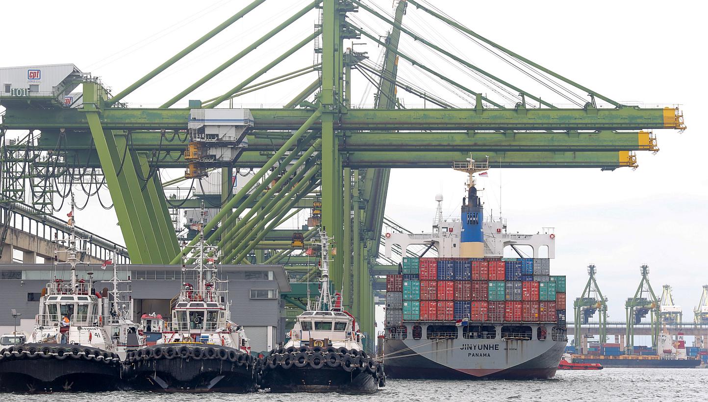 Quay cranes servicing a container ship berthed at the Pasir Panjang container terminal. -- PHOTO: ST FILE