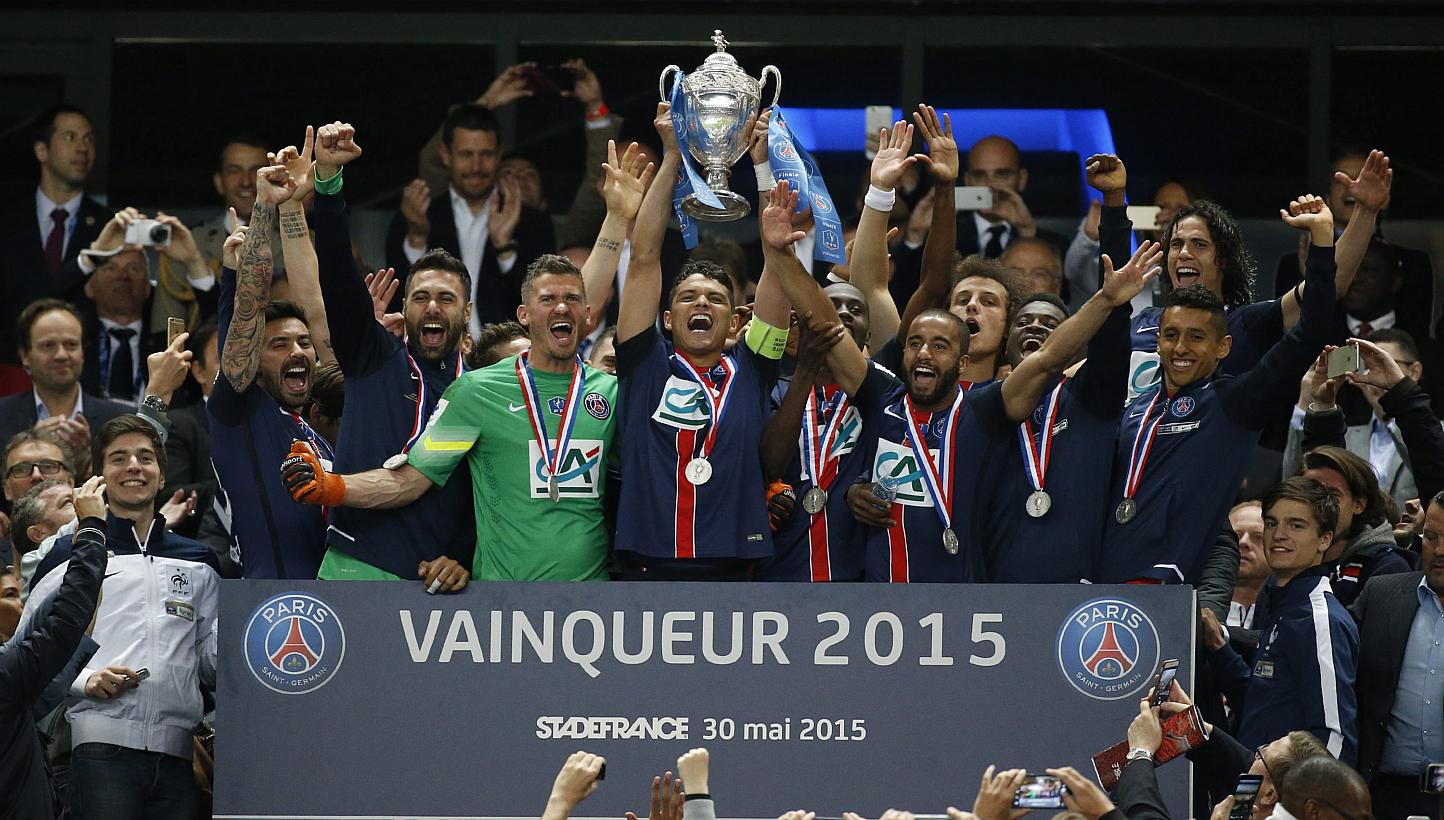 Paris St Germain's players celebrate with the trophy after winning the Coupe de France final match between Paris Saint Germain (PSG) and AJ Auxerre at the Stade de France in Saint-Denis outside Paris, France, on May 30, 2015. -- PHOTO: EPA&nbsp;