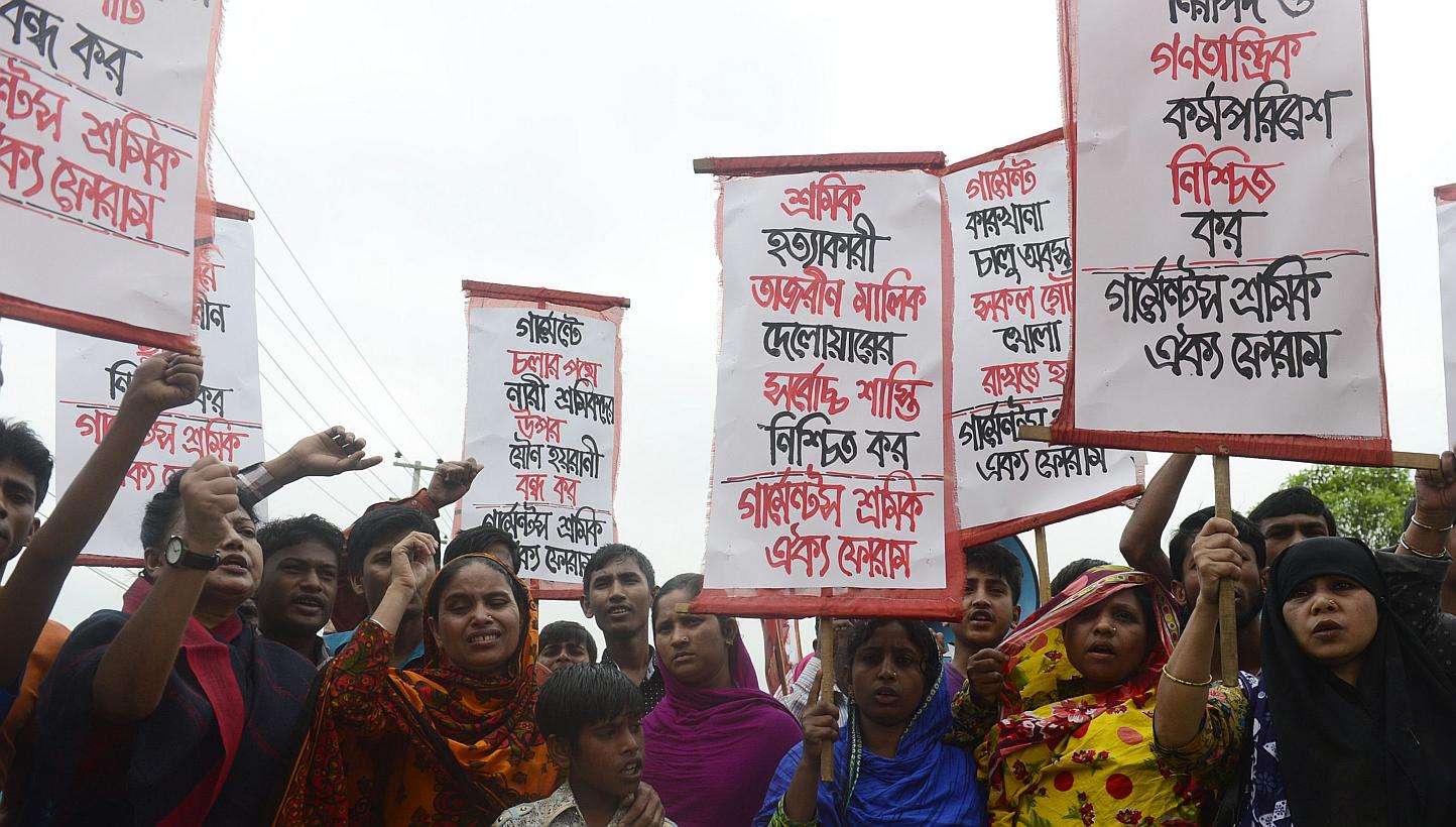 Memebers of Bangladeshi garments worker union shout slogans as they mark the second anniversary of the Rana Plaza building collapse at the site where the building once stood in Savar, on the outskirts of Dhaka on April 24, 2015. Bangladesh police sai