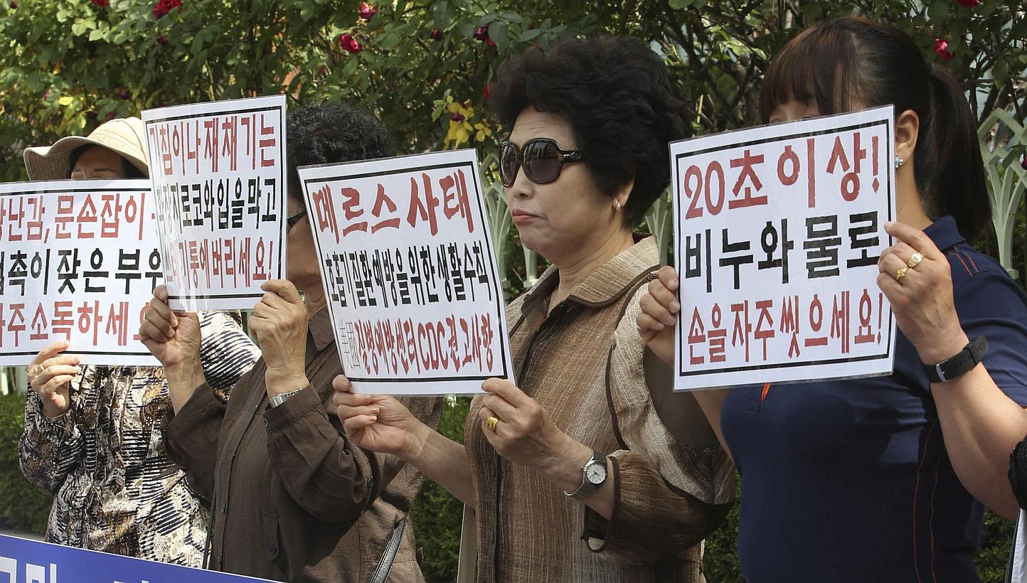 Members of a civic group on public health rally in front of the state-run National Health Insurance Service in Seoul, South Korea, on June 1, 2015, to urge the government to release information on places of residence related to patients infected with