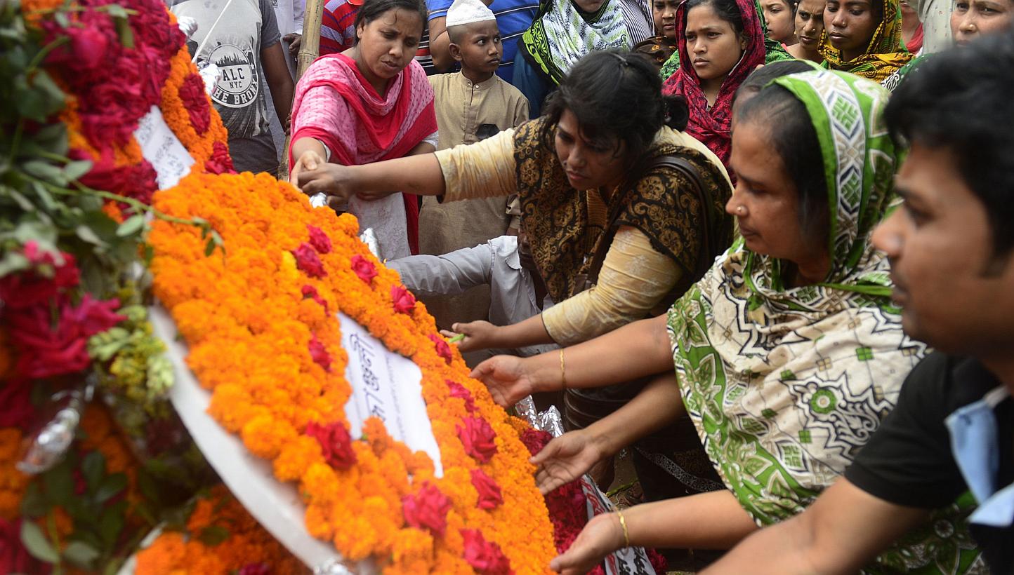 Bangladeshi people lay floral wreaths in memory of the victims of the Rana Plaza building collapse as they mark the second anniversary of the disaster in Savar, on the outskirts of Dhaka on April 24, 2015. Bangladeshi police on Monday, June 1, charge