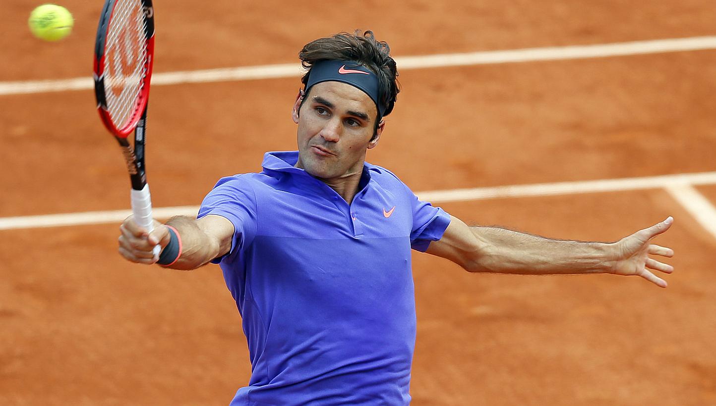 Roger Federer of Switzerland in action against Gael Monfils of France during their fourth round match for the French Open tennis tournament at Roland Garros in Paris, France on June 1, 2015. -- PHOTO: EPA