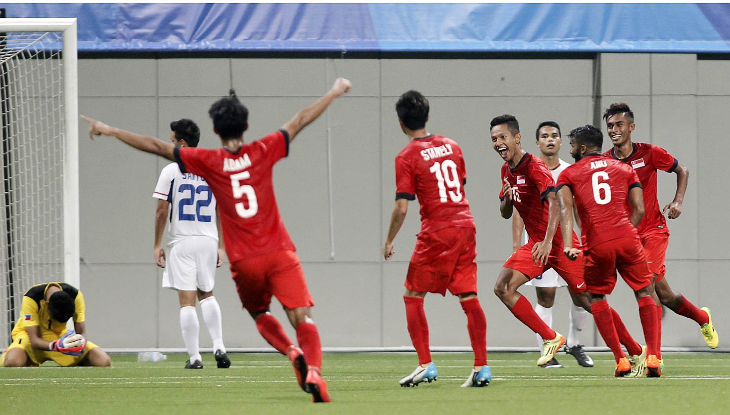 Singapore's Sheikh Abdul Hadi (fourth right) celebrates after scoring the match's only goal. -- PHOTO: REUTERS