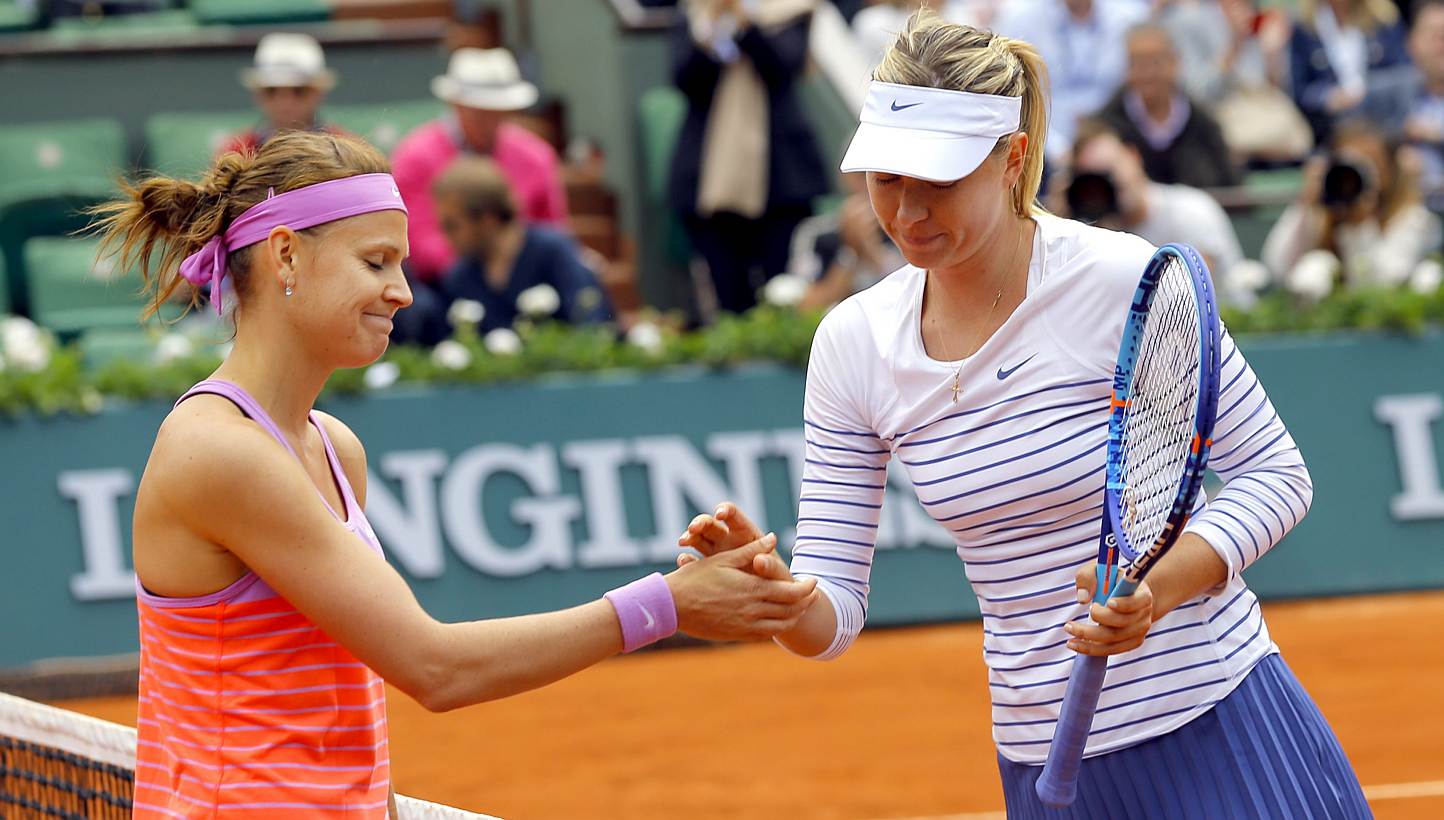 Lucie Safarova of Czech Republilc (left) shakes hands after winning against Maria Sharapova of Russia during their fourth round match for the French Open tennis tournament at Roland Garros in Paris, France on June 1, 2015. -- PHOTO: EPA