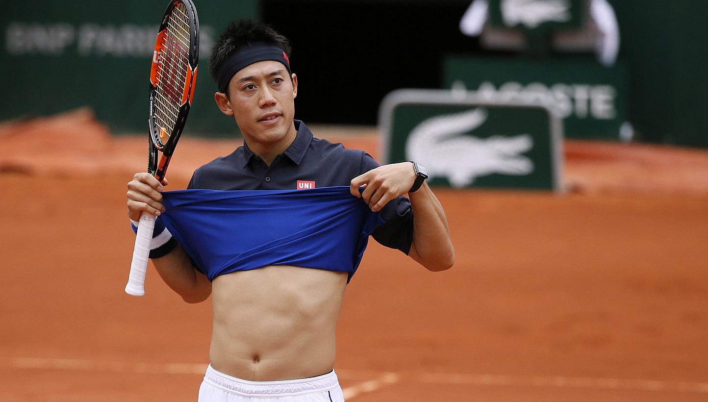 Japan's Kei Nishikori gestures during his match against Russia's Teymuraz Gabashvili during the men's fourth round of the Roland Garros 2015 French Tennis Open in Paris on Sunday (May 31). -- PHOTO: AFP