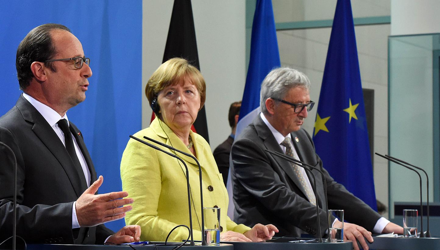 (Left to right) French President Francois Hollande, German Chancellor Angela Merkel and European Commission President Jean-Claude Juncker addressing a press conference prior to talks with representatives of the of the European Round Table of Industri