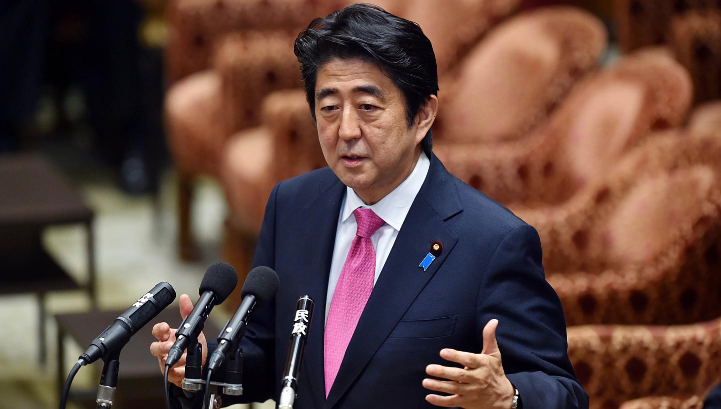 Japanese Prime Minister Shinzo Abe said on Tuesday he would pledge a 26 per cent cut in the country's greenhouse gas emissions, ahead of a global summit on climate change this year. -- PHOTO: AFP