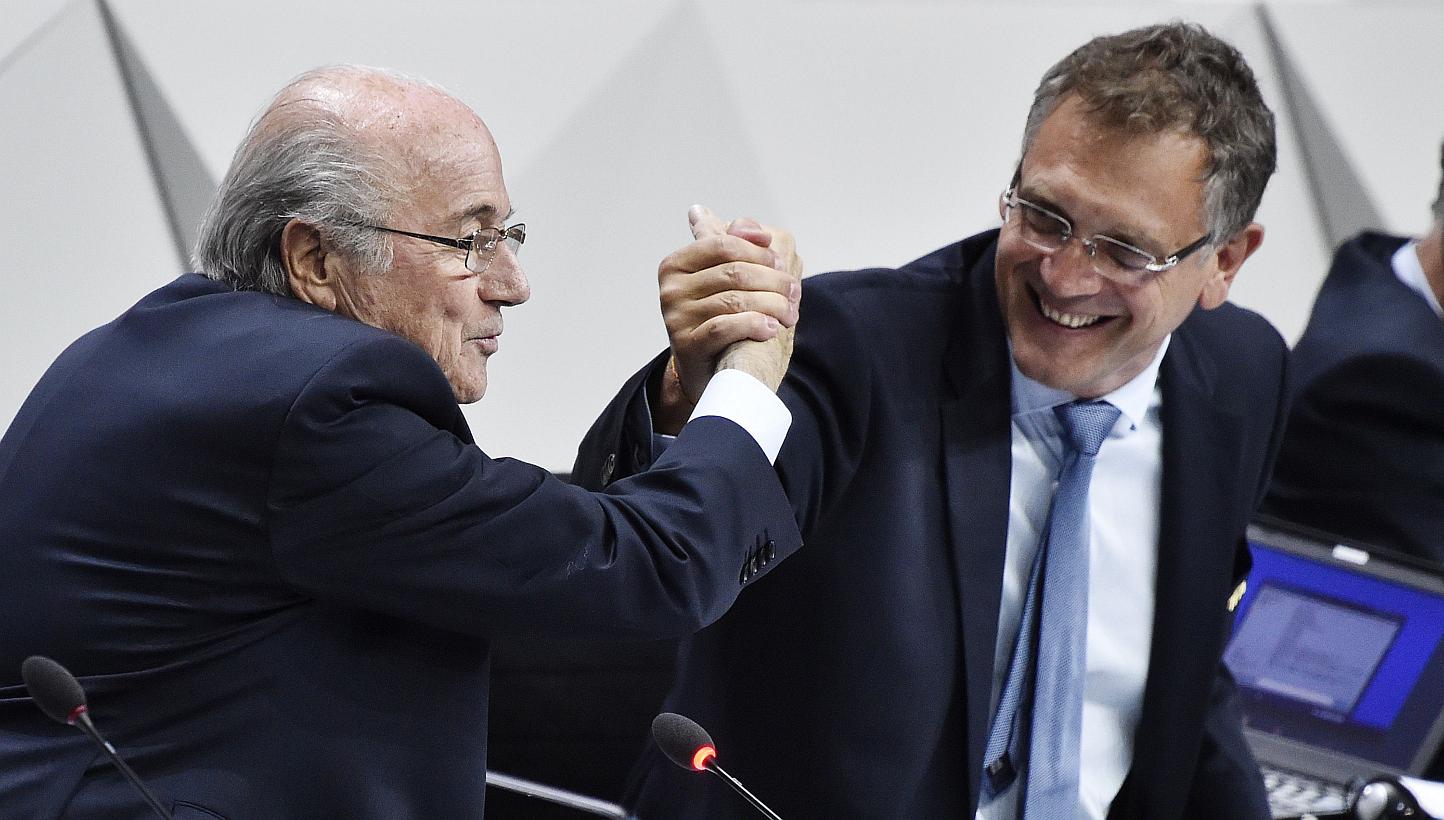This May 29, 2015 file photograph shows Fifa President Sepp Blatter (left) shaking hands with Fifa general secretary Jerome Valcke (right) during the 65th Fifa Congress in Zurich, Switzerland. -- PHOTO: AFP 