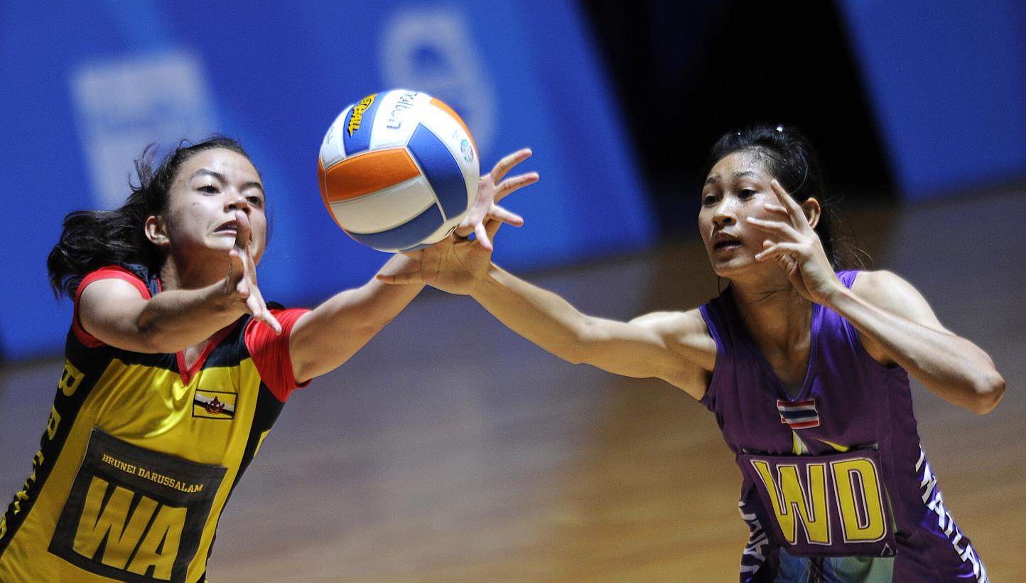 Brunei's Dk Khalisha Pg Abd Rahman (left) with Thailand's Paweena Kamwan in action at the 28th SEA Games. Brunei threatened to cause an upset against Thailand in the SEA Games netball competition on Tuesday, but ran out of steam in the end as Thailan