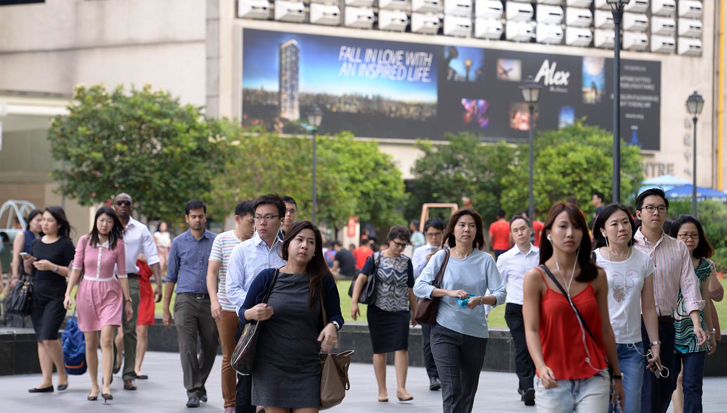 Office workers at Raffles Place on Feb 18, 2015. Employees in Singapore could see their salaries grow by 4.4 per cent this year, on the back of low inflation, according to a survey released on Tuesday. -- ST PHOTO: DANIEL NEO