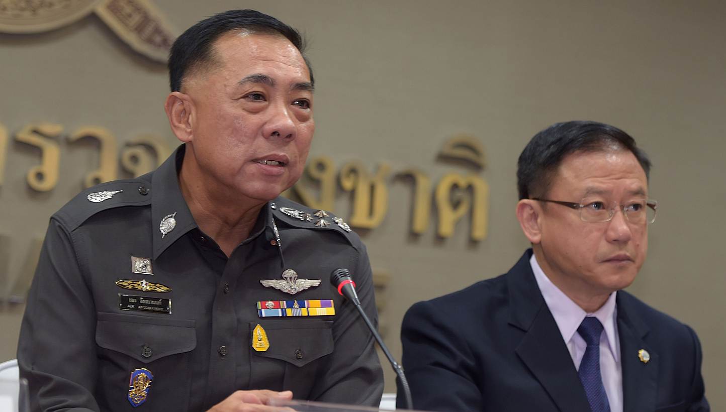 Thai police General Aek Angsananont (left) answers a question from journalists next to Anti-Money Laundering Office secretary-general Seehanat Prayoonrat (right) at police headquarters in Bangkok on June 2, 2015. A Thai court has issued an arres