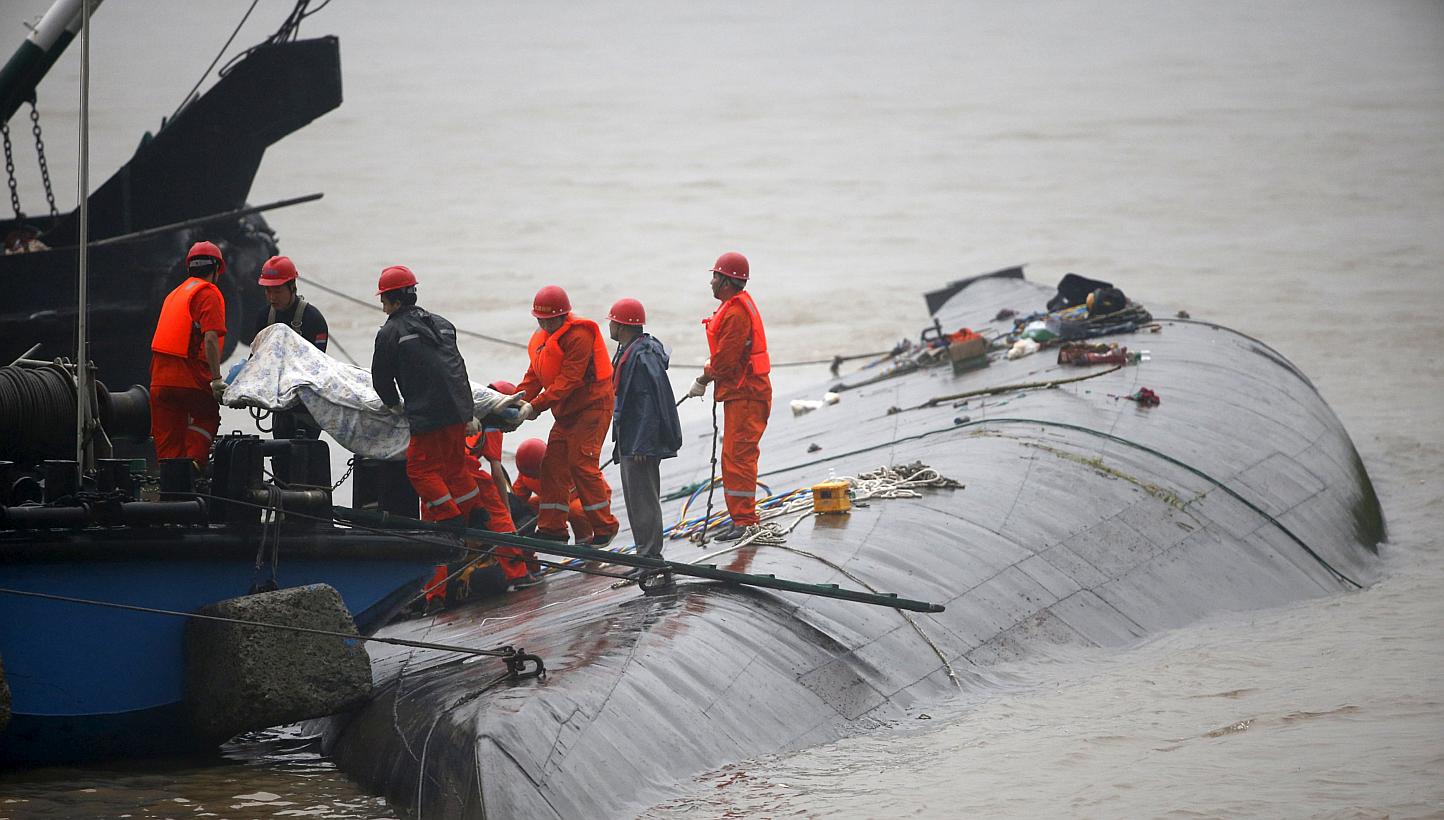 Rescue workers carry a body from a sunken ship in the Jianli section of Yangtze River, Hubei province, China, on June 2, 2015. The sinking of the cruise boat is likely to mar the country's generally clean maritime safety record, which hasn't suffered