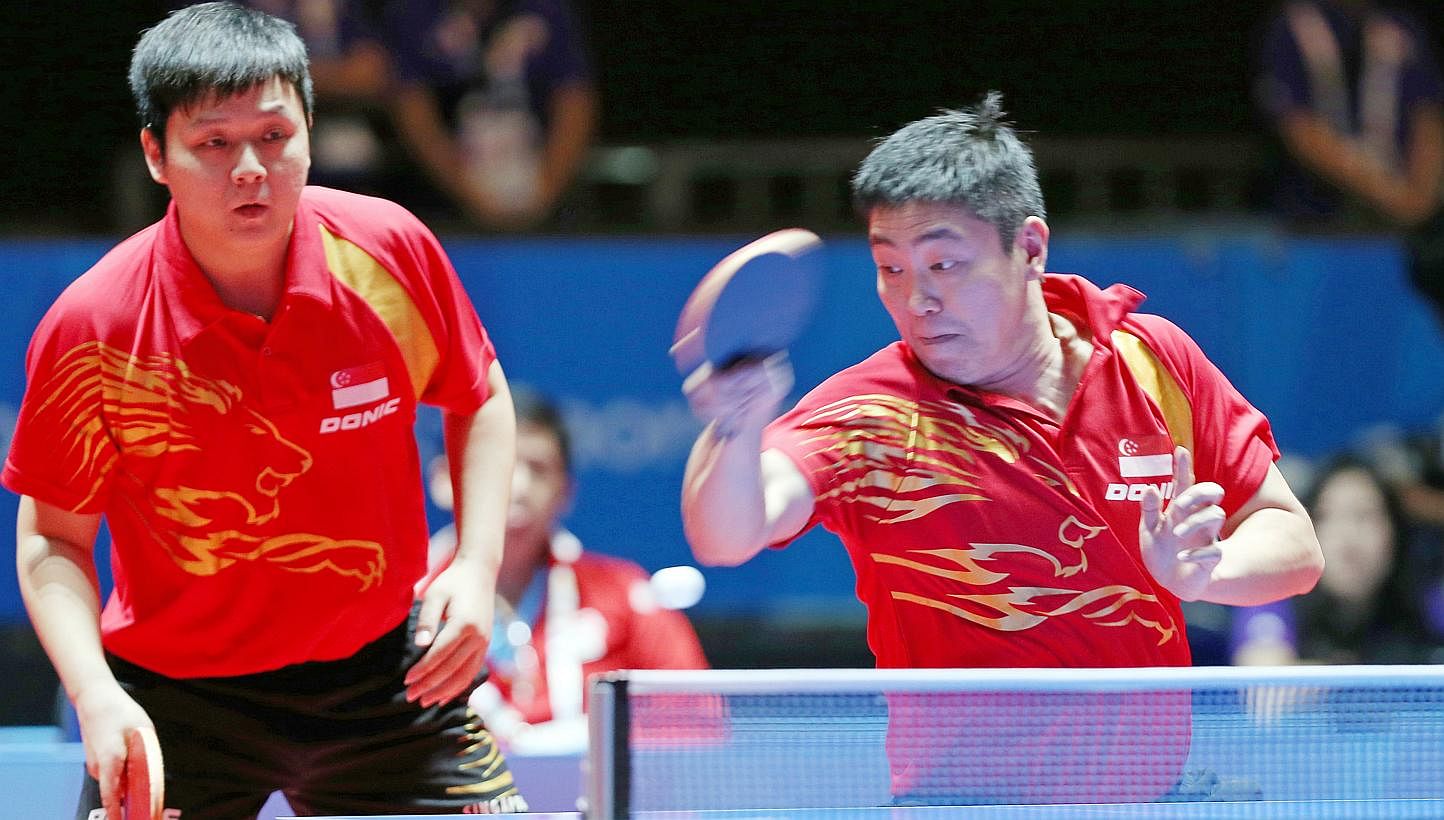 Favourites Gao Ning (right) and Li Hu beat Thailand's Tanviriyavechakul Padasak and Udomsilp Chanakarn in the table tennis men's doubles final to make it two gold medals for Singapore at the 28th SEA Games on Tuesday night . -- ST PHOTO: SEAH KWANG P