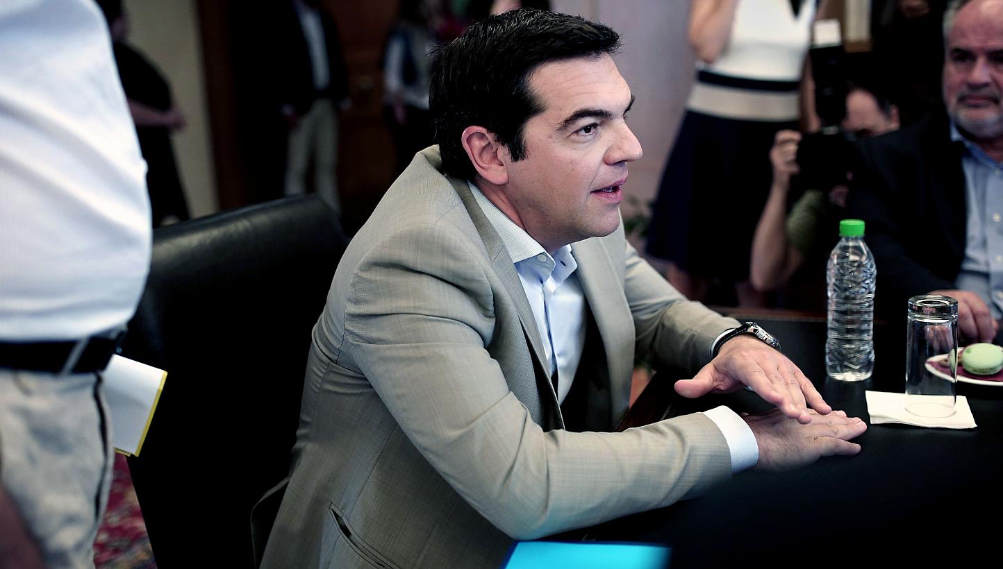 Greek Prime Minister Alexis Tsipras (centre) meeting the Minister of Culture, Education and Religious Affairs Aristides Baltas in Athens on June 2, 2015. -- PHOTO: AFP