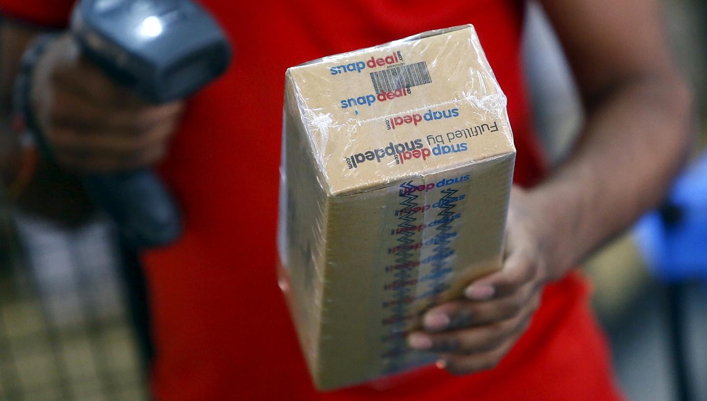 A worker of Indian e-commerce company Snapdeal.com scanning barcode on a box after it was packed at the company's warehouse in New Delhi on April 20, 2015. -- PHOTO: REUTERS