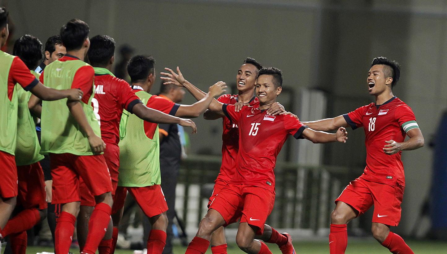 Singapore's under-23 defender Sheikh Abdul Hadi Sh Othman (No.15) celebrating with his teammates after scoring the goal against the Philippines at the 28th Sea Games held at the Jalan Besar Stadium on June 1, 2015. Singapore's coach Aide Is