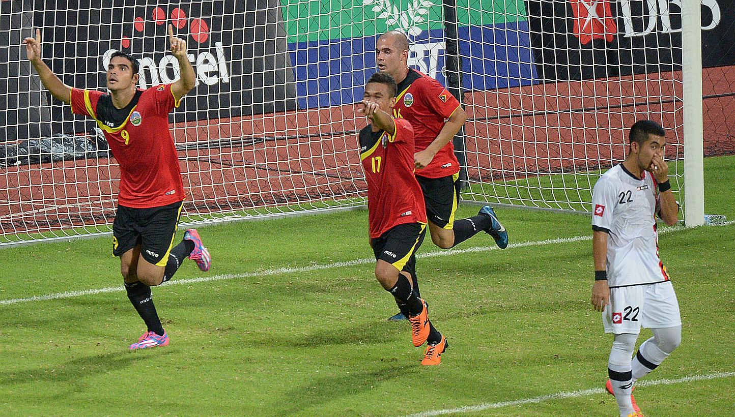 Far left: Timor Leste #9 Jairo Pinnheiro celebrating after he scored the first goal score at the Brunei half.&nbsp;-- ST PHOTO: DESMOND WEE