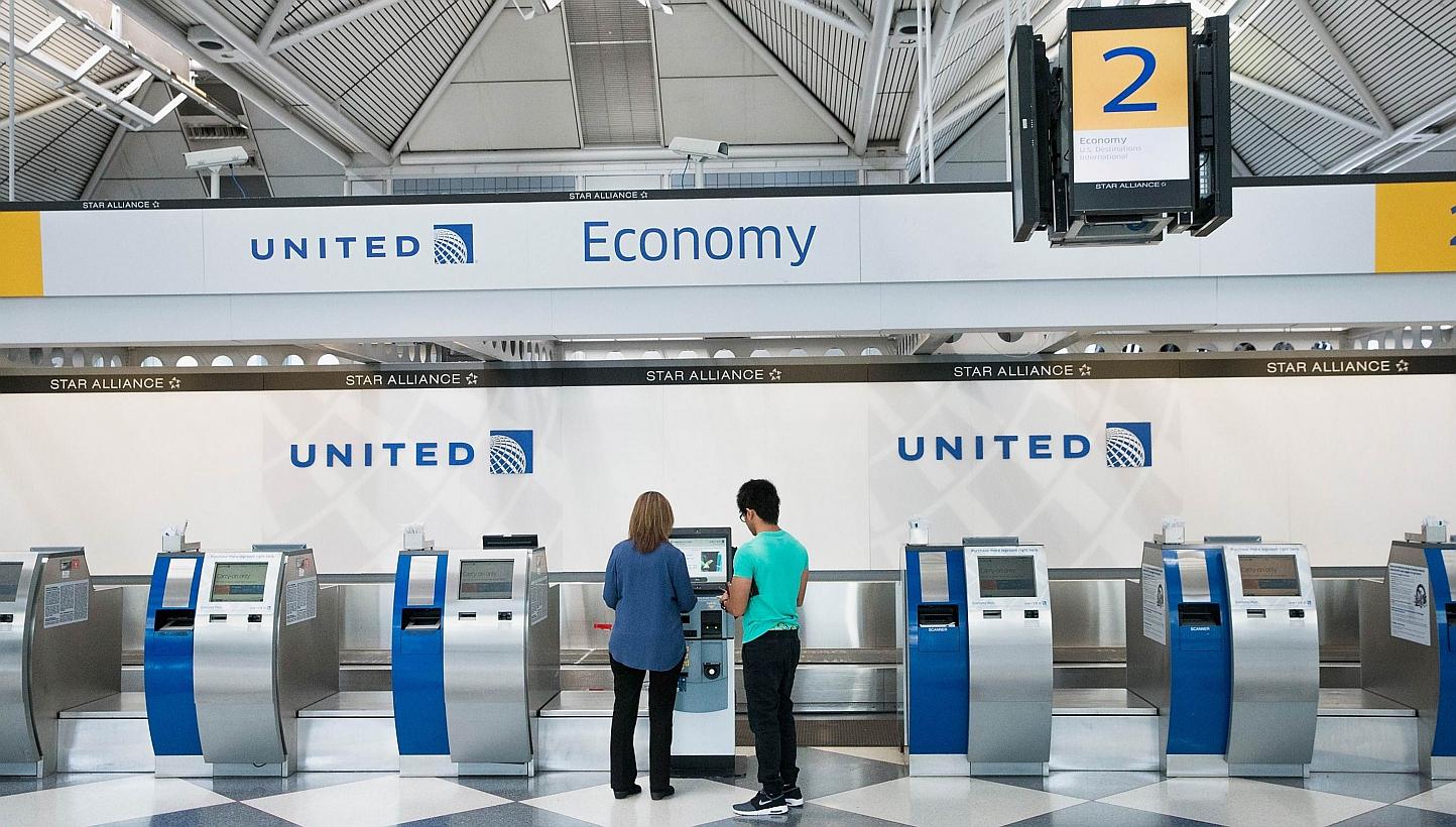Passengers check-in for flights with United Airlines at O'Hare Airport on Tuesday in Chicago, Illinois. United travelers experienced widespread delays this morning after the airline was forced to ground flights after reports of bomb threats being mad