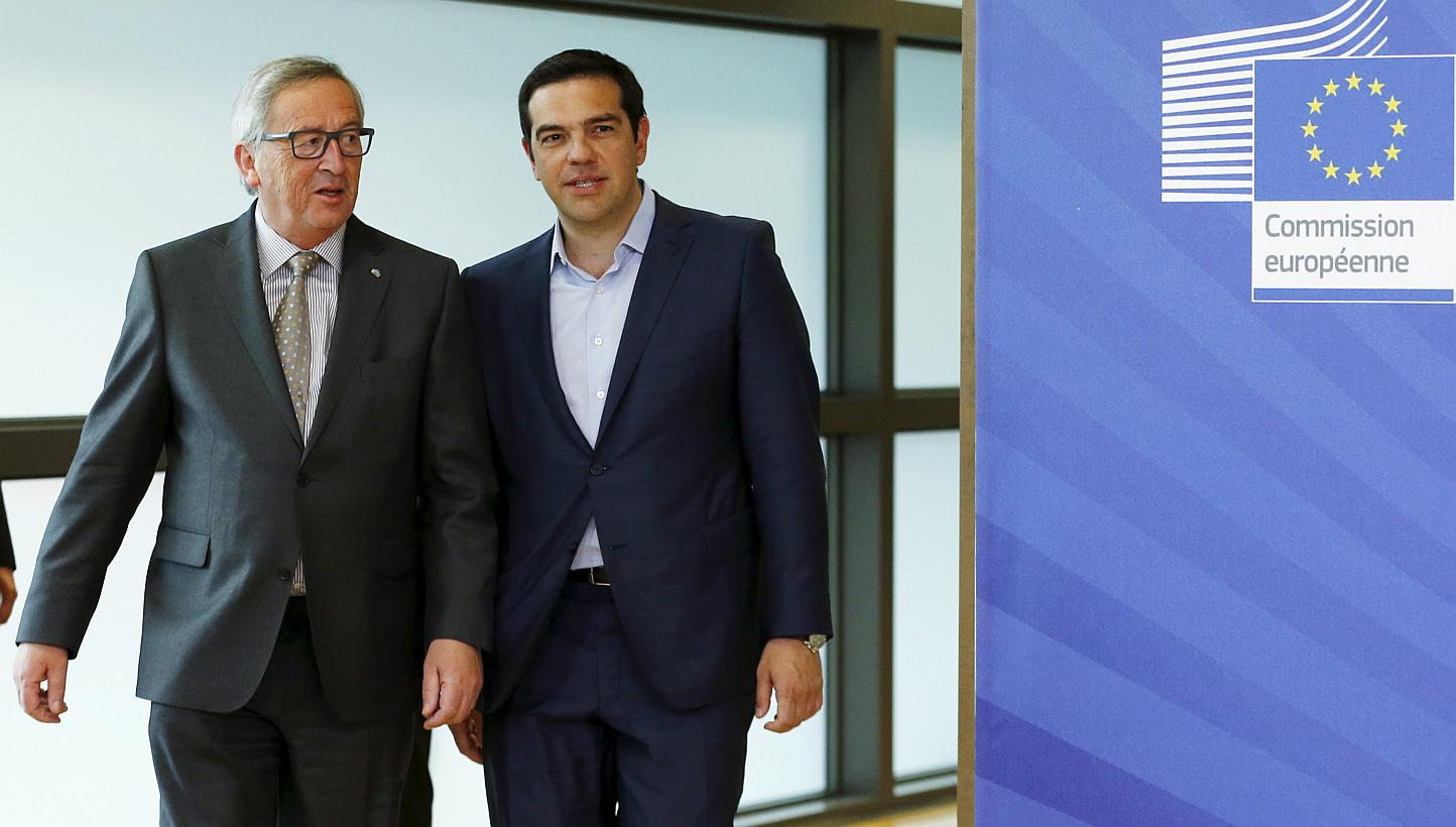 Greek Prime Minister Alexis Tsipras walks with European Commission President Jean-Claude Juncker (left) ahead of a meeting at the EU Commission headquarters in Brussels, Belgium, on June 3, 2015. -- PHOTO: REUTERS