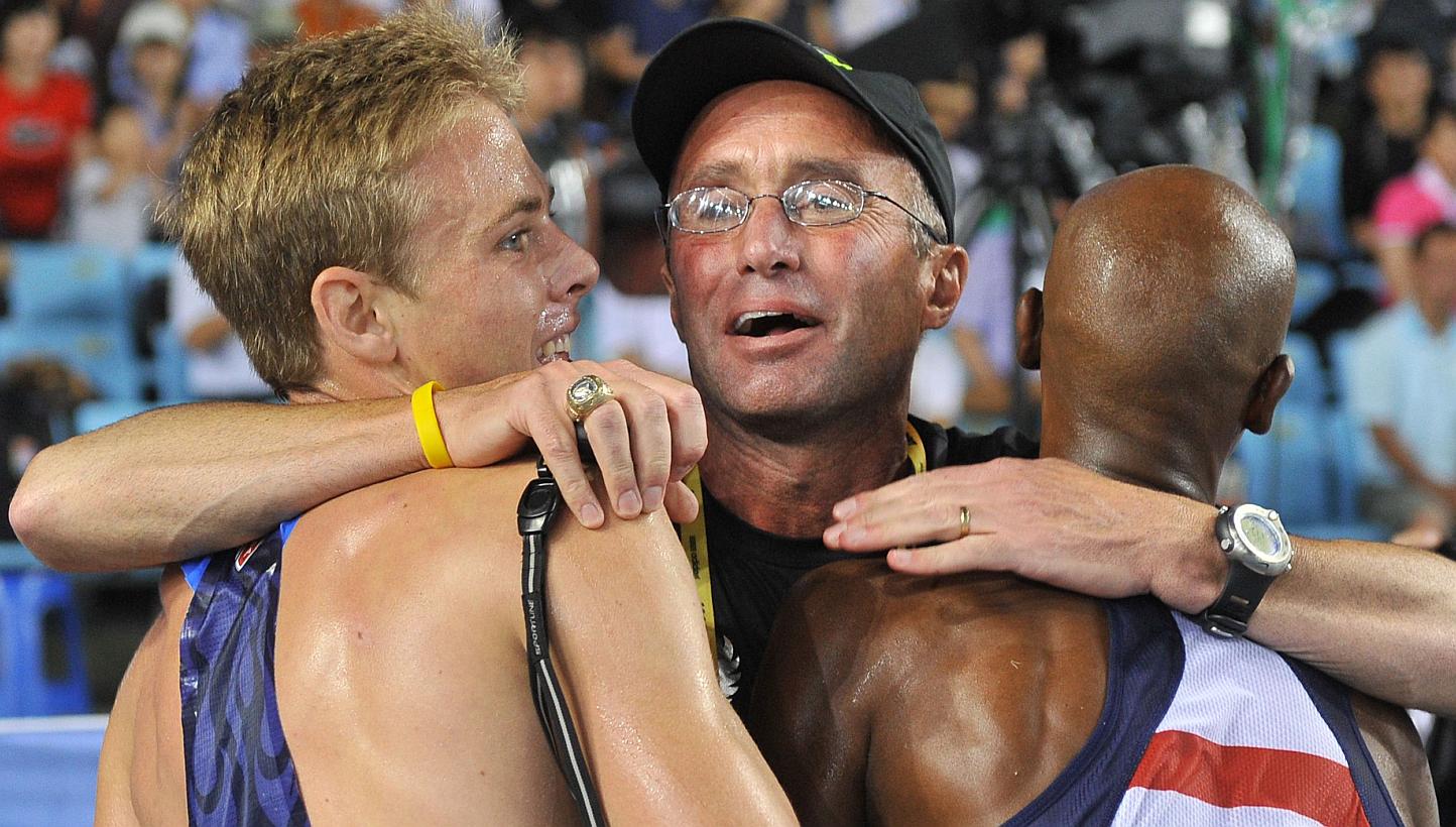 A photograph taken on Sept 4, 2011, shows US coach Alberto Salazar (centre) hugging US athlete Bernard Lagat (right) and US athlete Galen Rupp following the men's 5,000 metres final at the International Association of Athletics Federations (IAAF) Wor