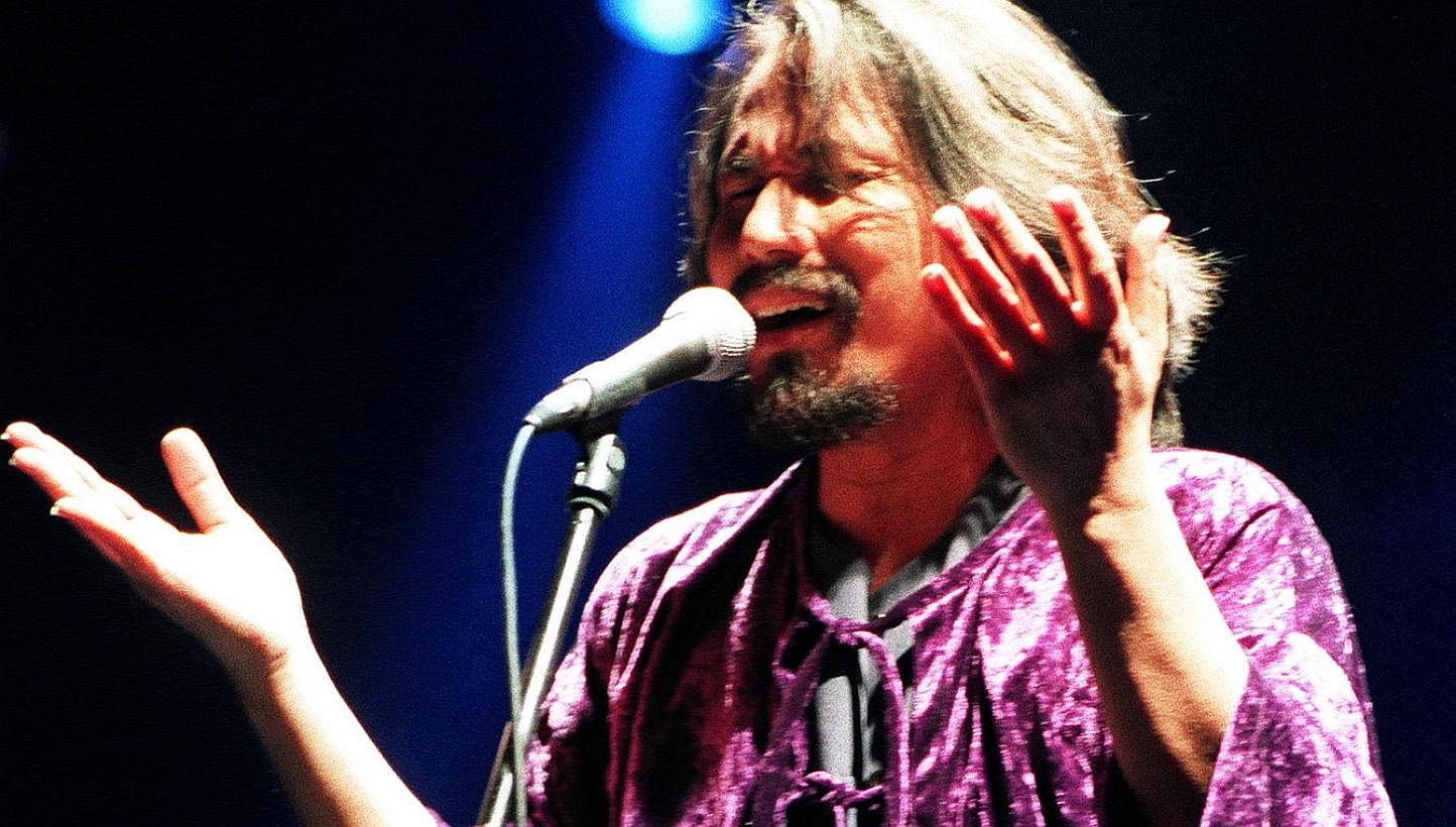 Prolific singer-songwriter M. Nasir (left), who also put on concerts (above, in a 1990s gig), introduced ethnic influences to contemporary pop to keep the Malay culture alive.
