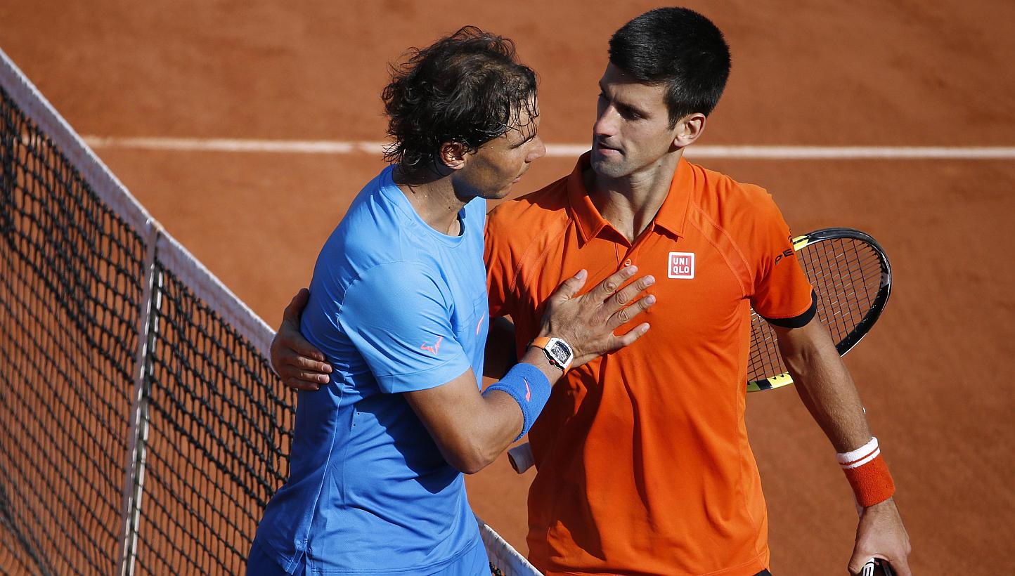 Spain's Rafael Nadal (left) shakes hands with Serbia's Novak Djokovic at the end of their men's quarter final match of the Roland Garros 2015 French Tennis Open in Paris on June 3, 2015. -- PHOTO: AFP