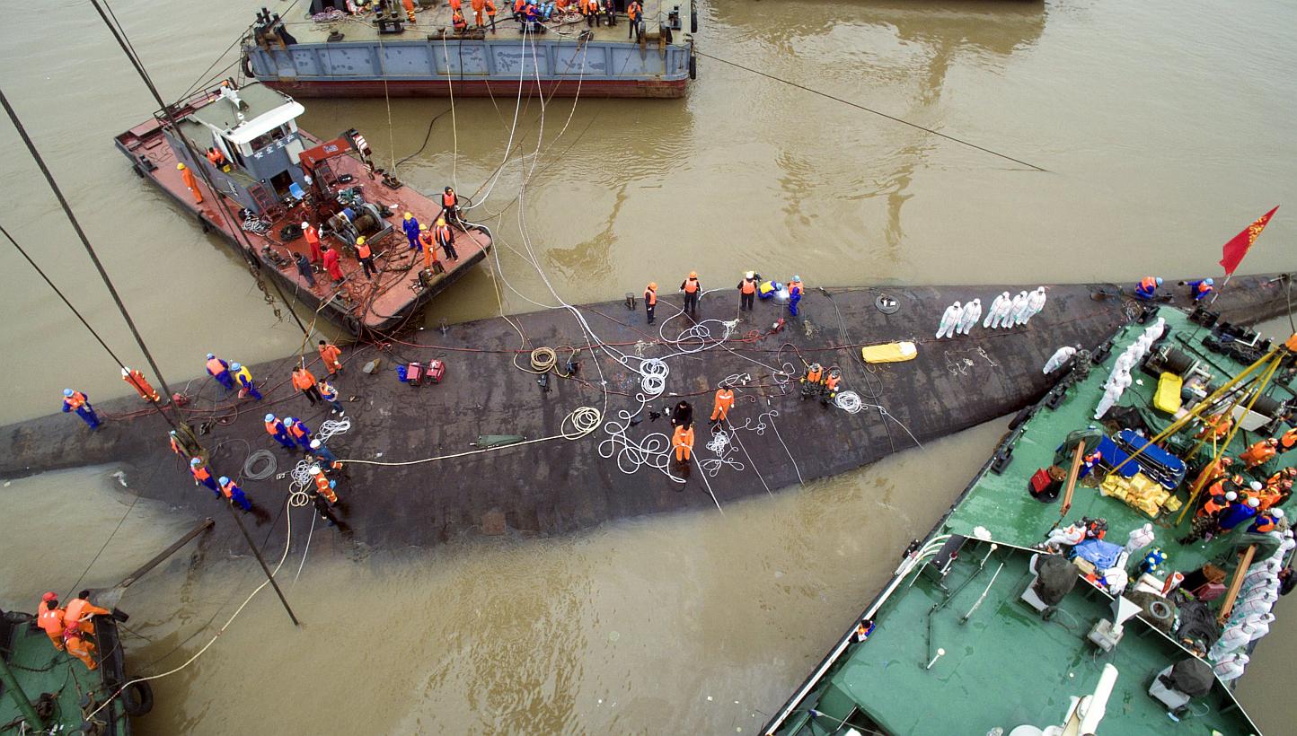 An aerial view shows rescue workers standing on the sunken cruise ship Eastern Star in Jianli, Hubei province, China on June 4, 2015. Rescue officials on Thursday began the operation to right the vessel. -- PHOTO: REUTERS
