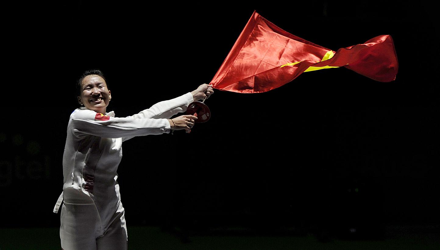 Vietnam's Tran Thi Len celebrates winning the womens individual Epee final, beating Harlene Raguin from the Philippines 11-7. -- PHOTO: REUTERS &nbsp;