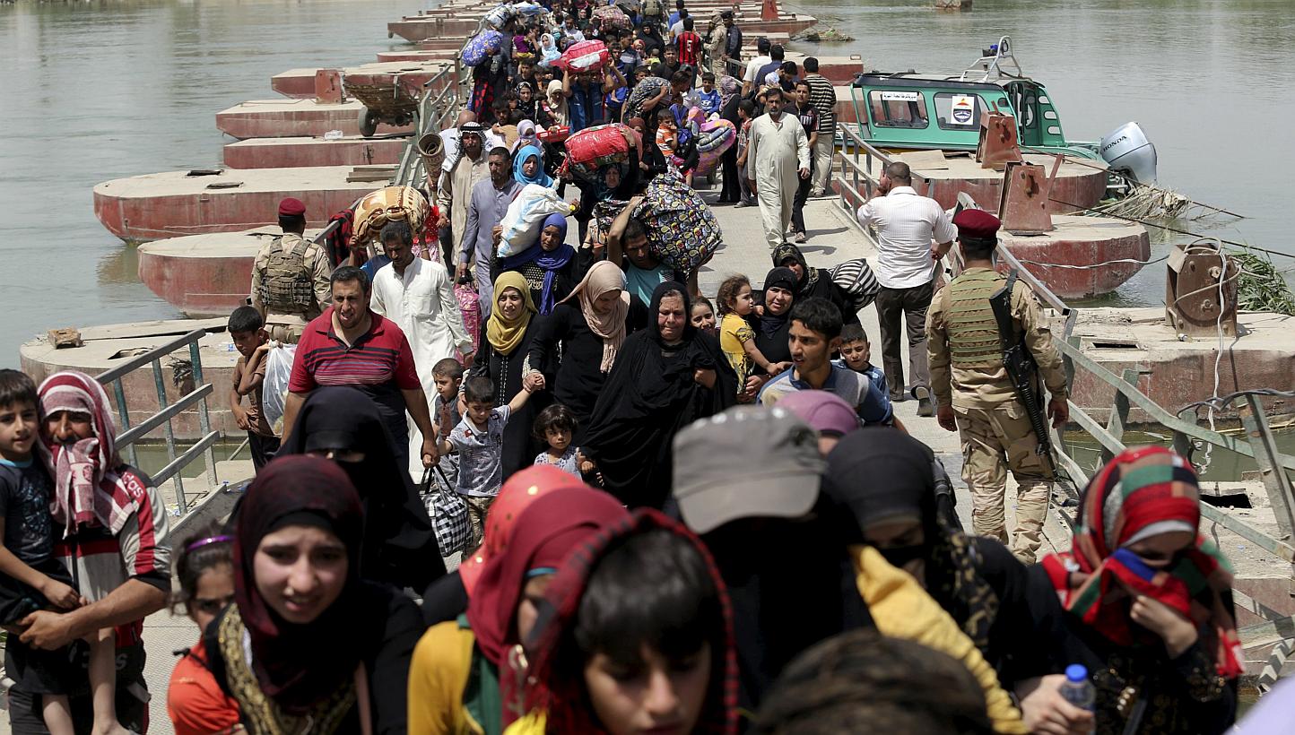 Displaced Sunni people fleeing the violence in Ramadi, cross a bridge on the outskirts of Baghdad on May 24, 2015. The United Nations is appealing for US$497 million (S$670 million) to pay for shelter, food and water over the next six months for 5.6 